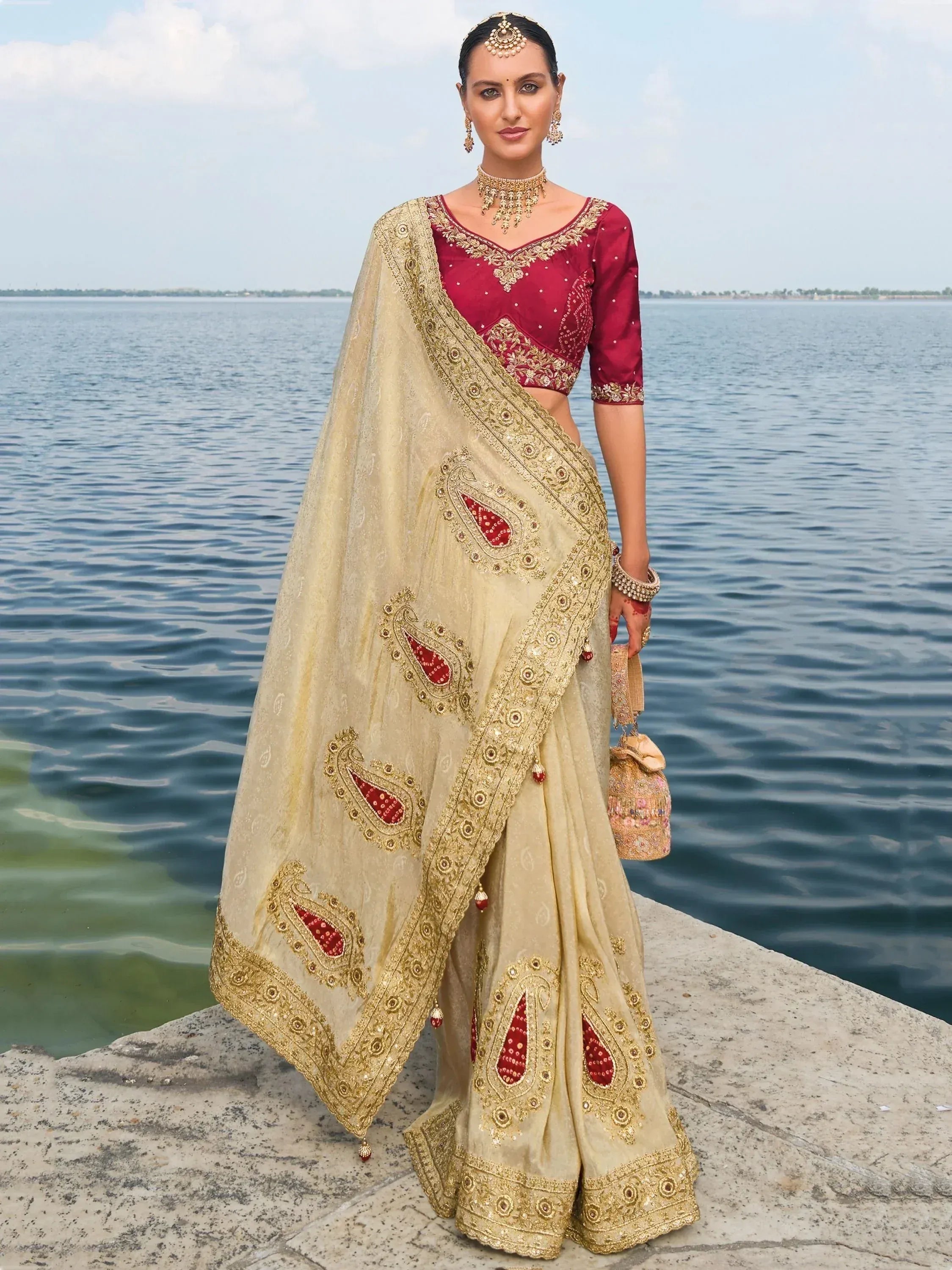 Elegant beige and red embroidered saree with gold detailing, perfect for Indian ethnic occasions