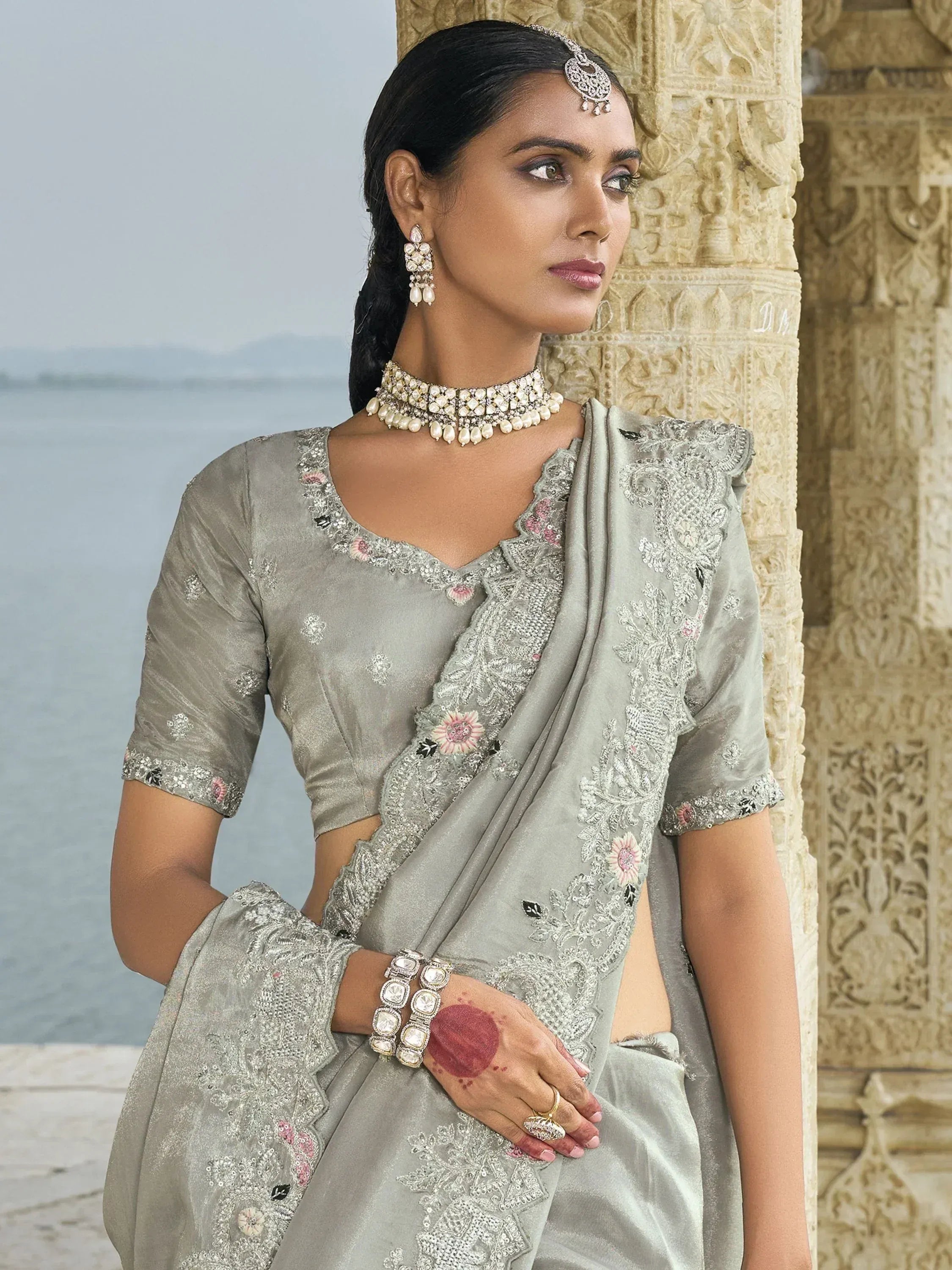 Grey embroidered saree with floral detailing, traditional Indian ethnic wear, paired with pearl jewelry