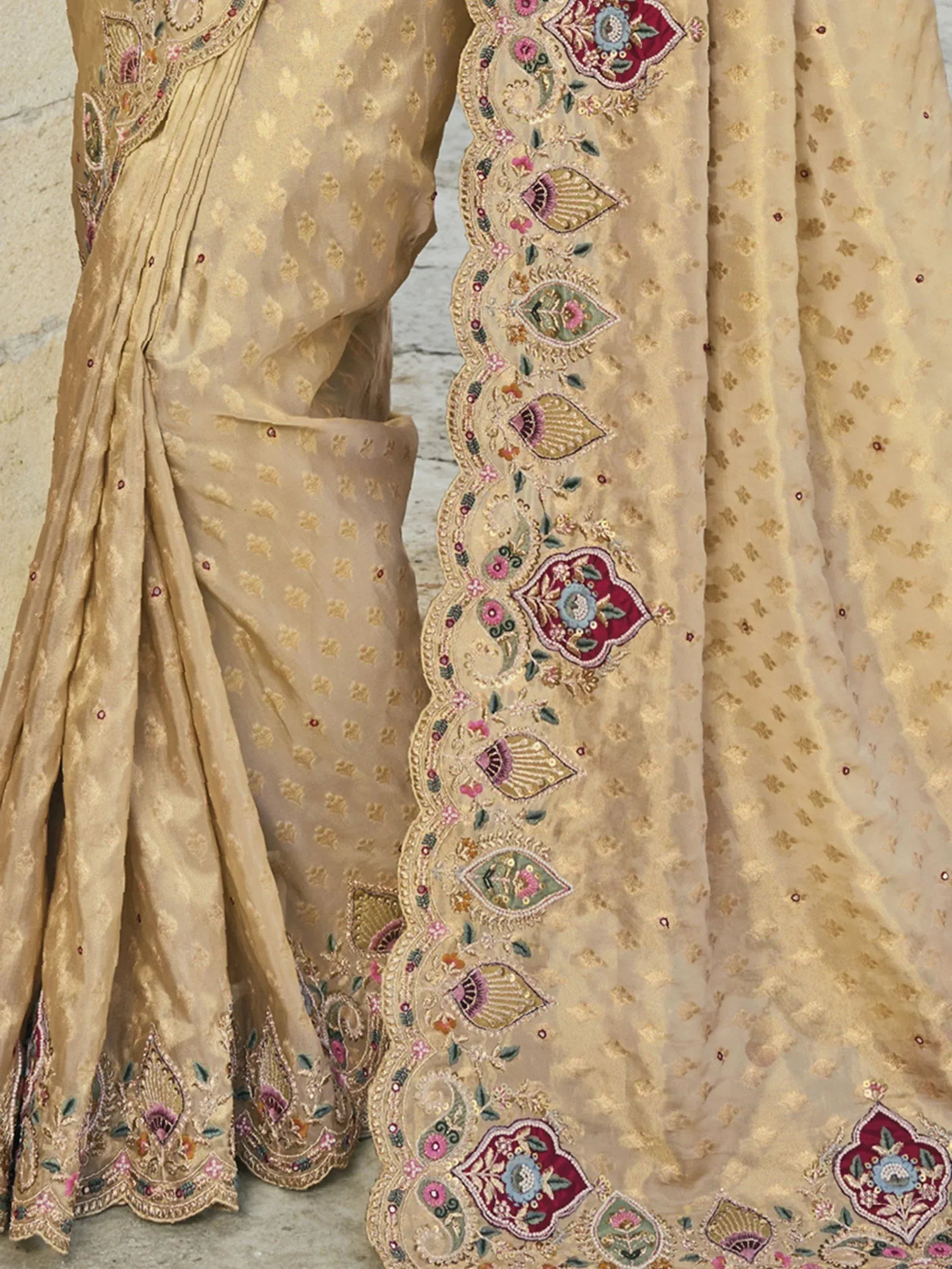 Beige designer lehenga choli with floral embroidery and gold motifs, ethnic Indian wear