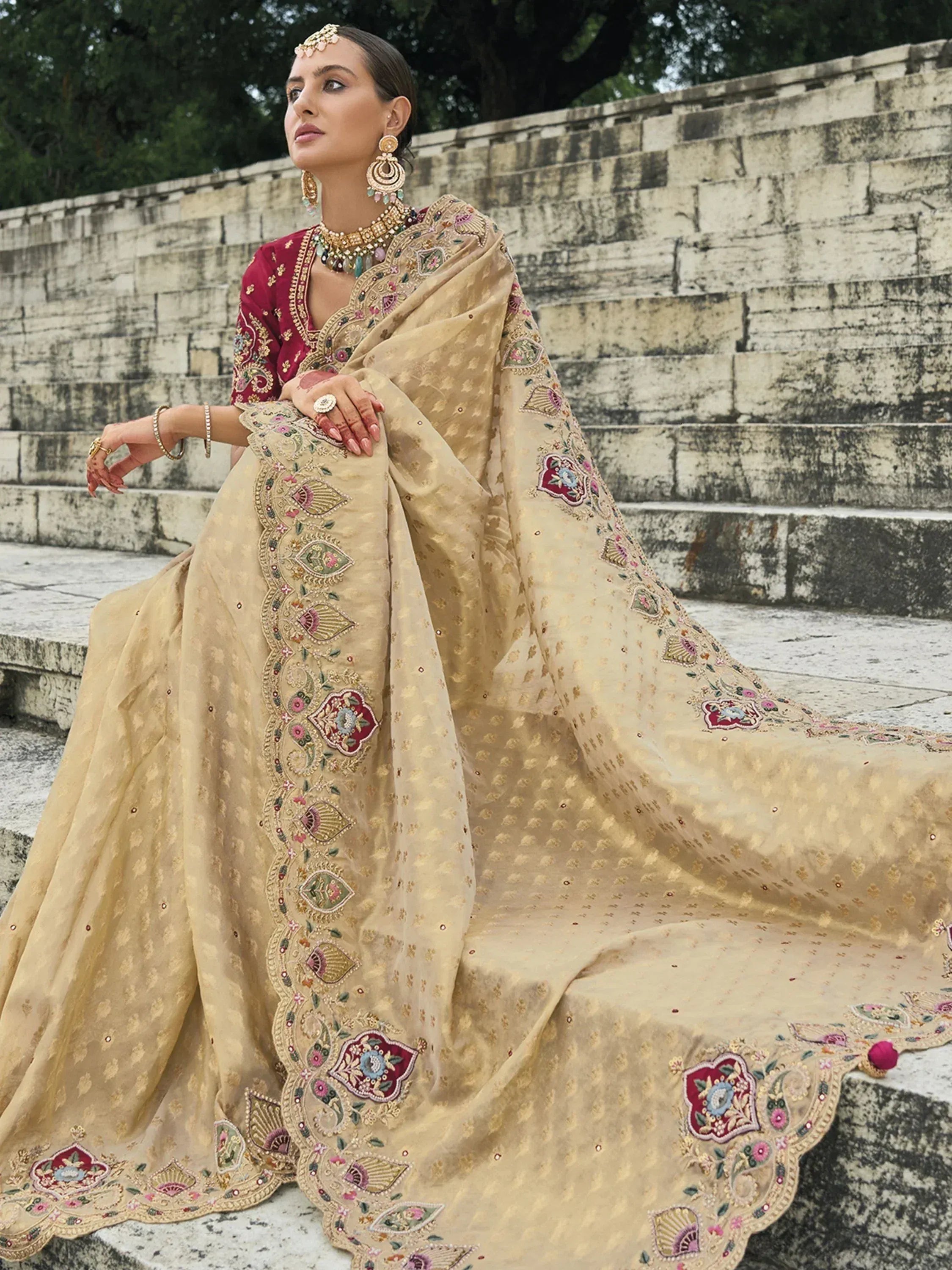Woman in elegant beige embroidered lehenga choli with floral motifs, traditional Indian ethnic wear