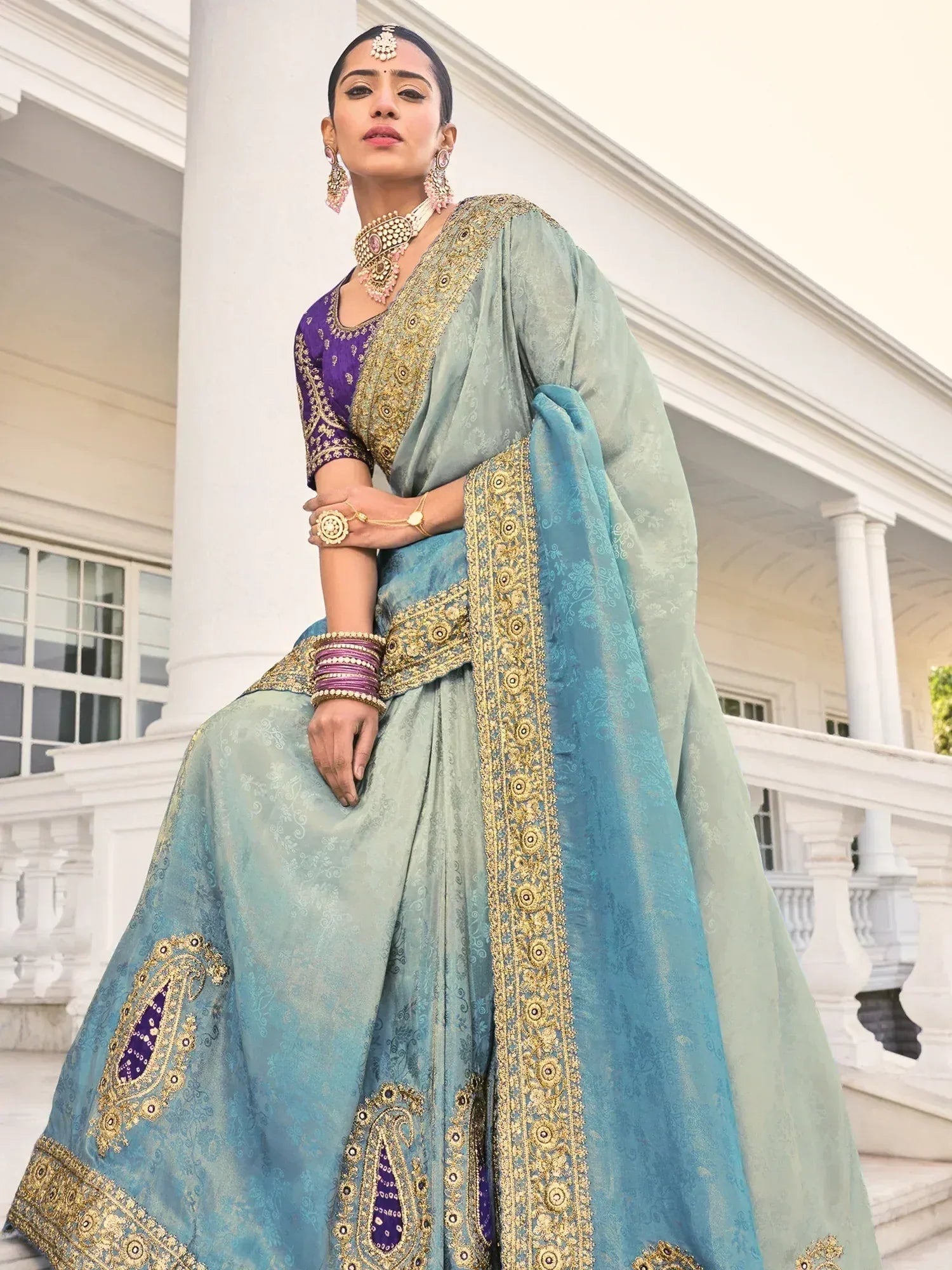 Elegant blue and purple designer lehenga choli with gold embroidery, perfect for Indian weddings and festive occasions.