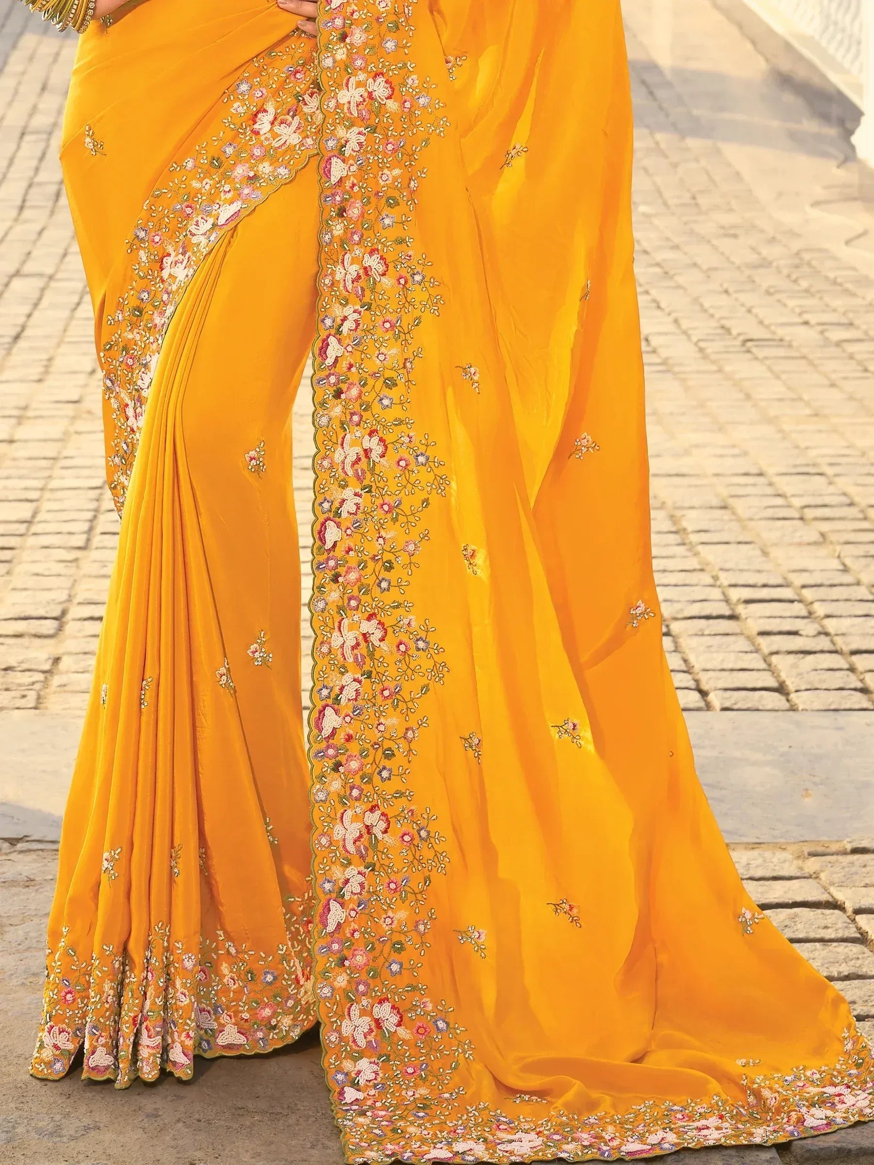Vibrant yellow saree with intricate floral embroidery, perfect for Indian ethnic wear occasions.