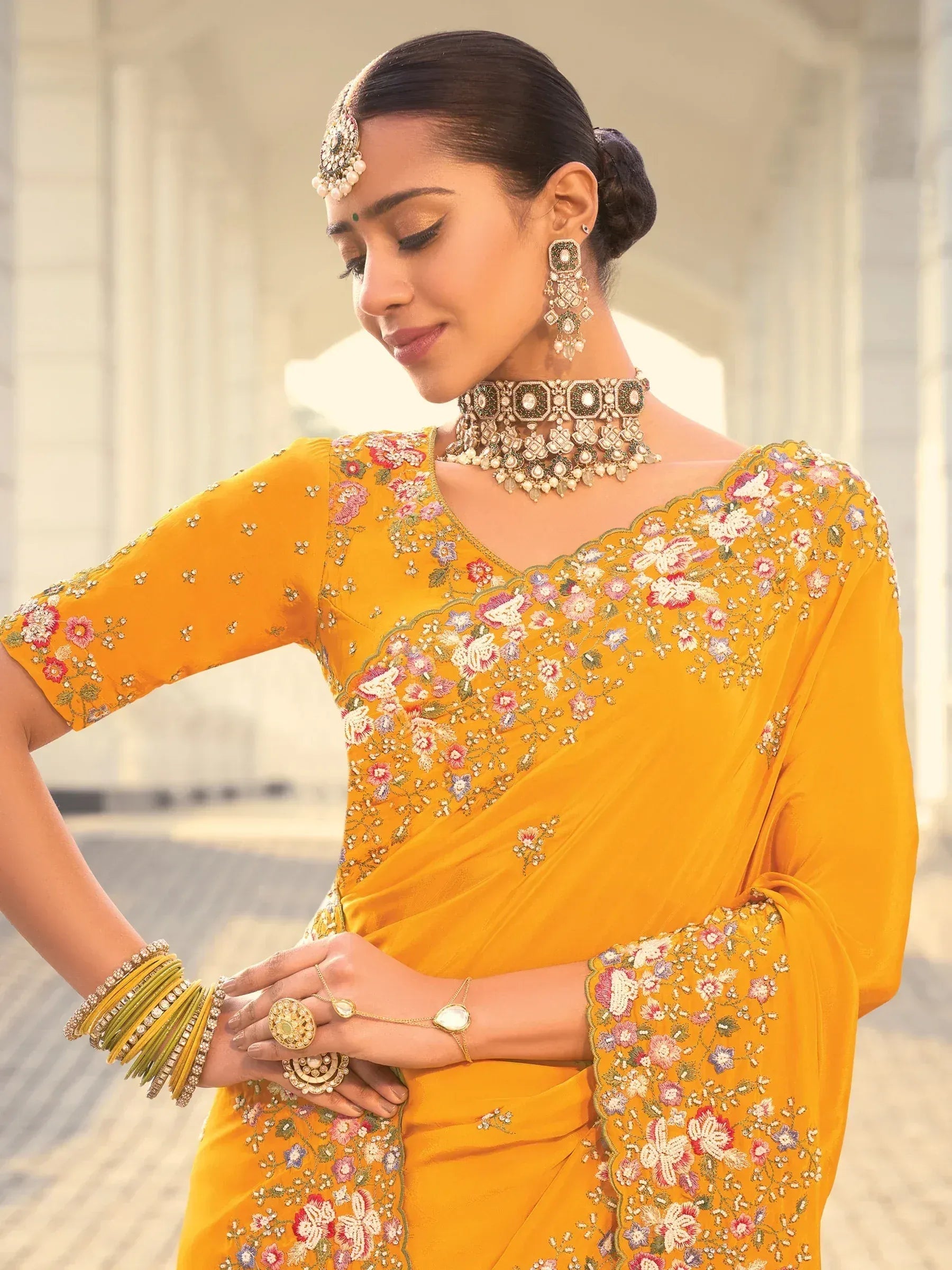 Yellow floral embroidered saree with traditional Indian jewelry for ethnic wear