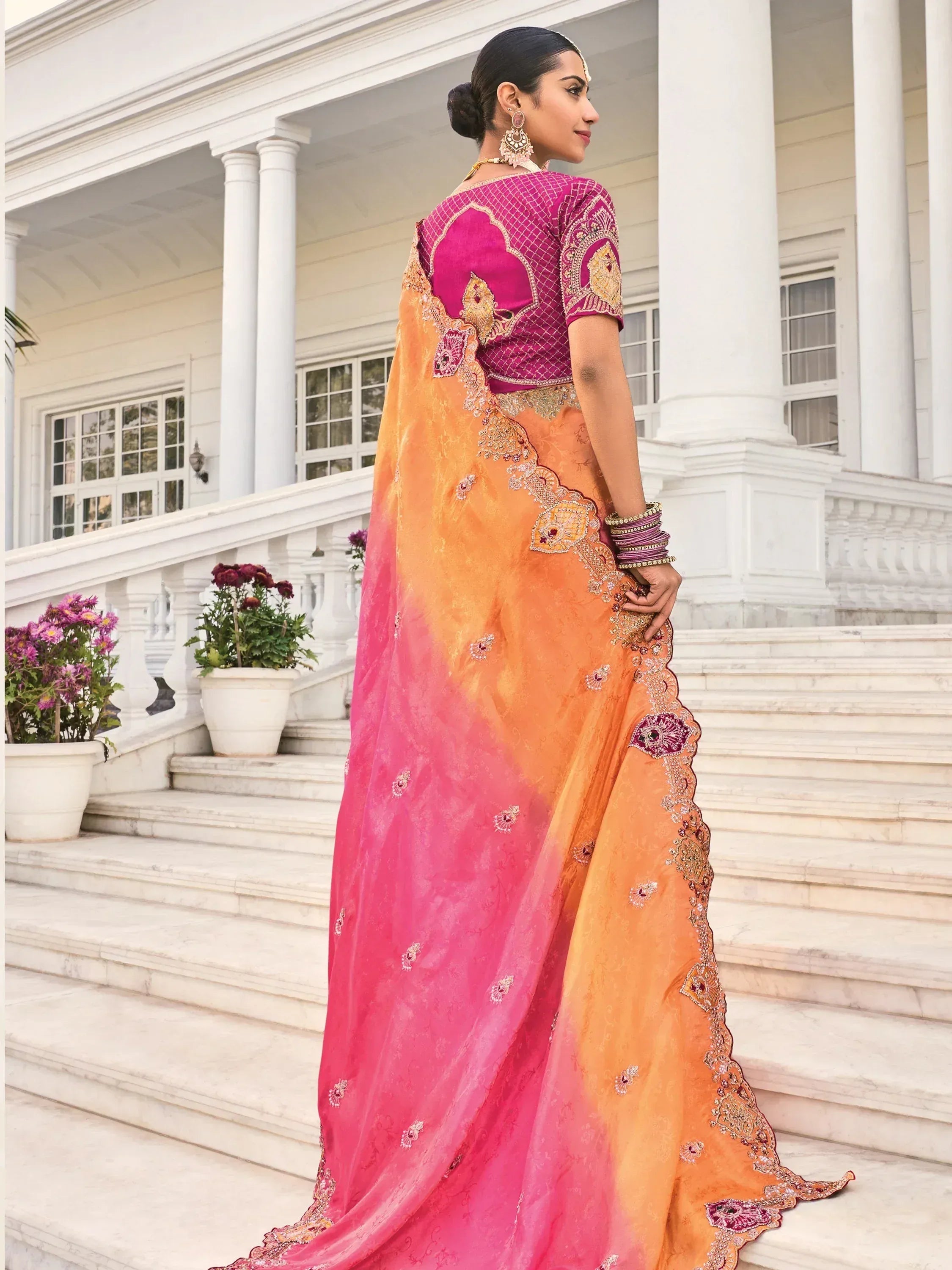 Elegant pink and orange saree with intricate embroidery, perfect for Indian ethnic wear occasions.