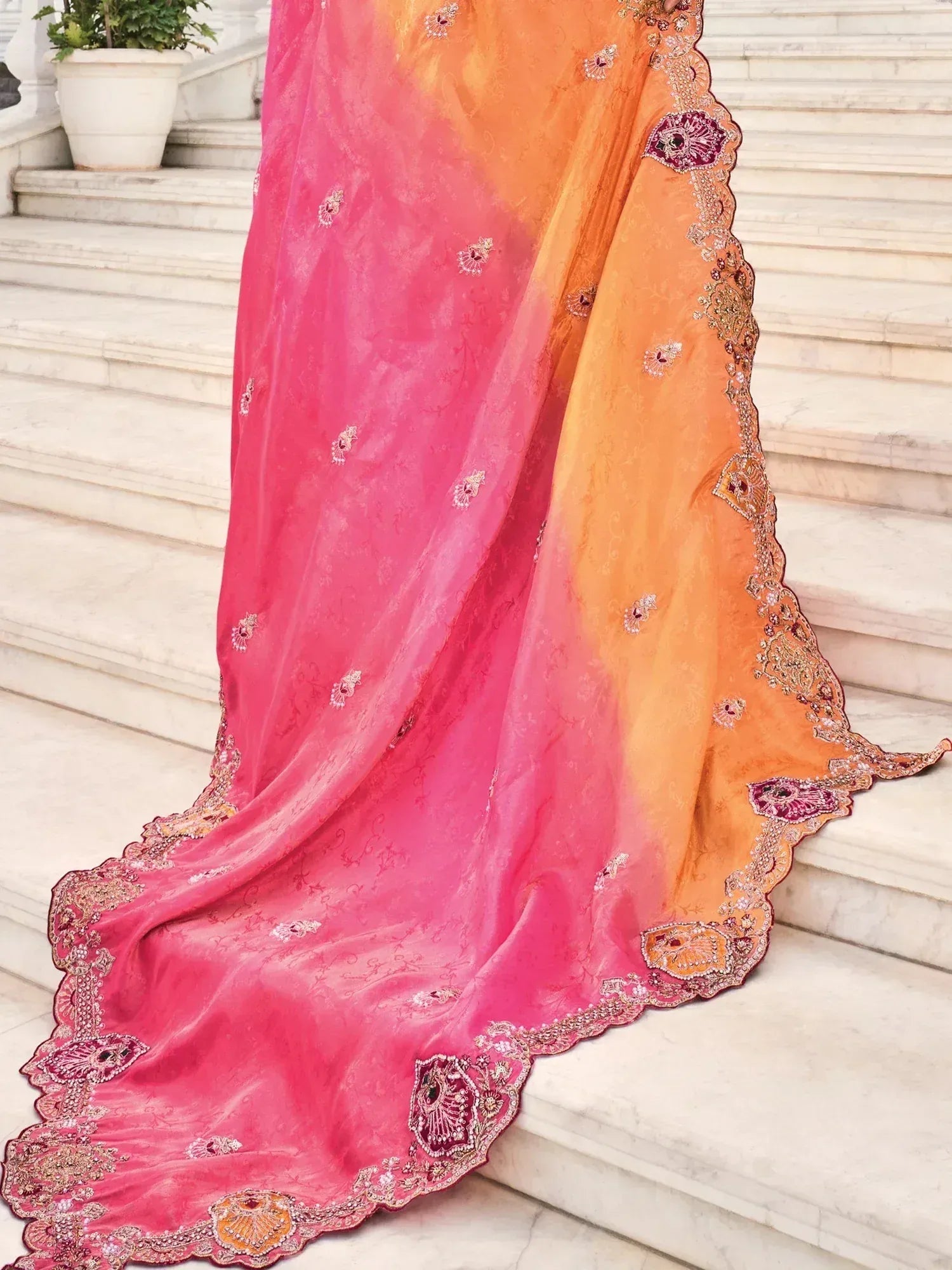 Elegant pink and orange designer saree with intricate embroidery, perfect for ethnic wear occasions.
