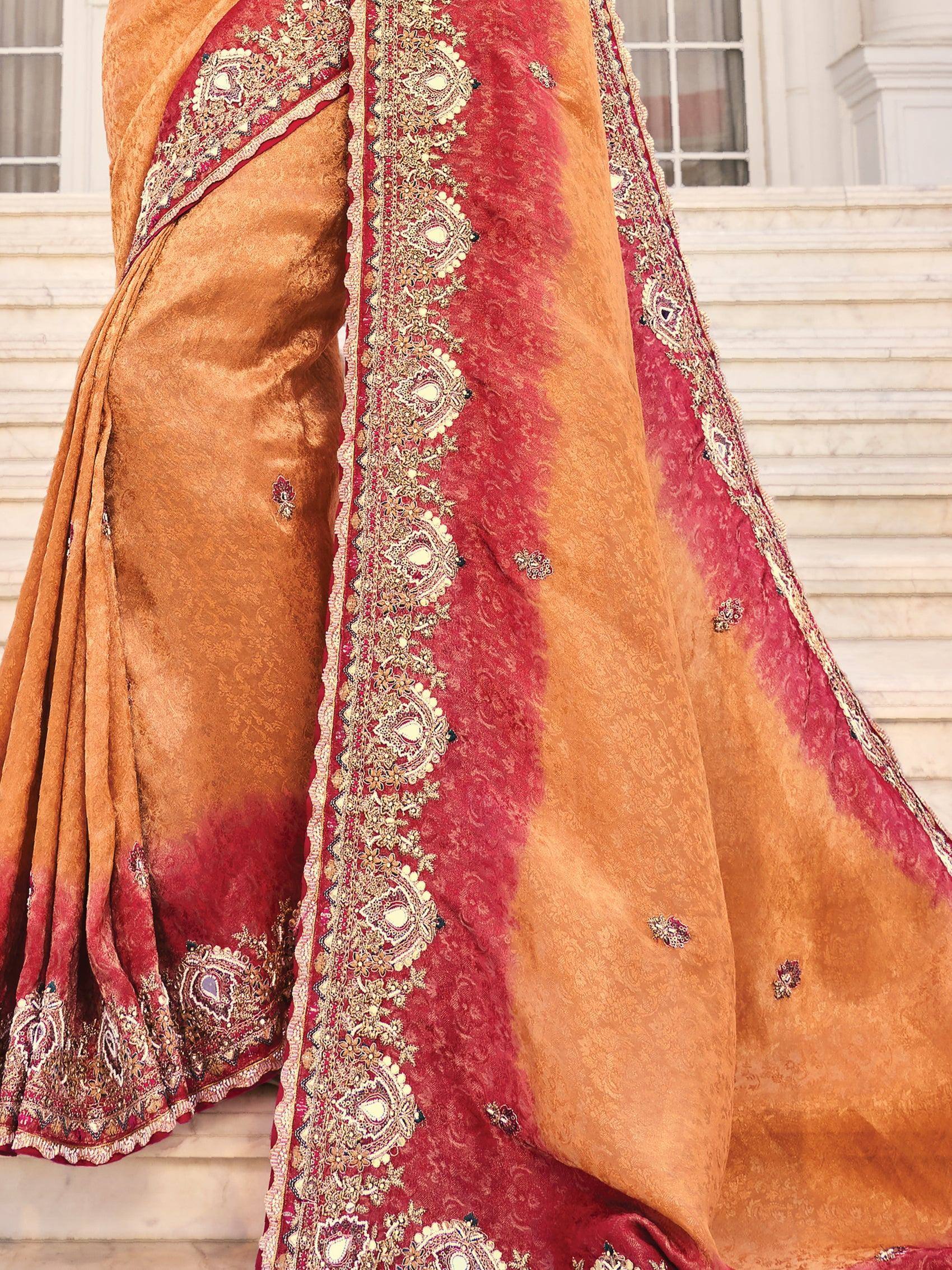 Elegant Indian saree with intricate gold embroidery and rich maroon-orange gradient design