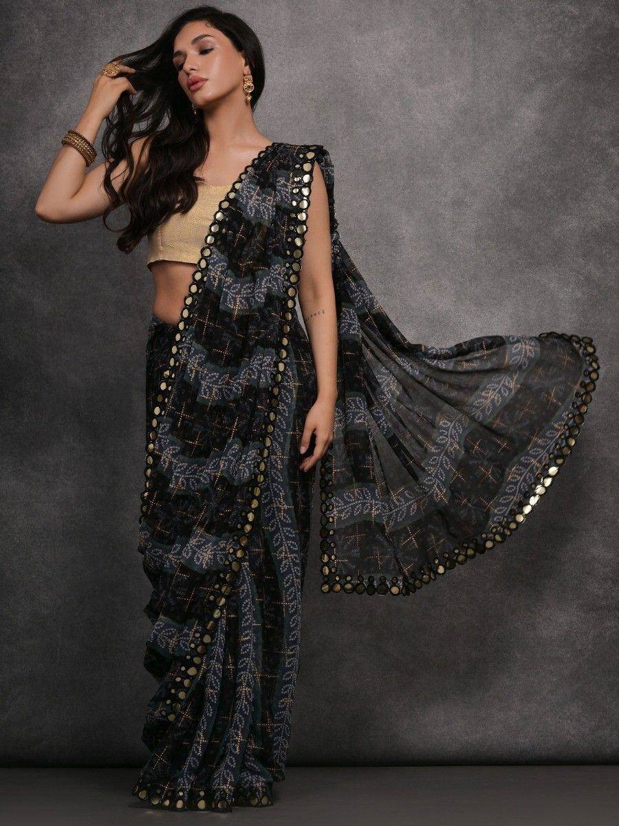 Black printed saree with gold mirror work, paired with golden blouse, ethnic Indian wear