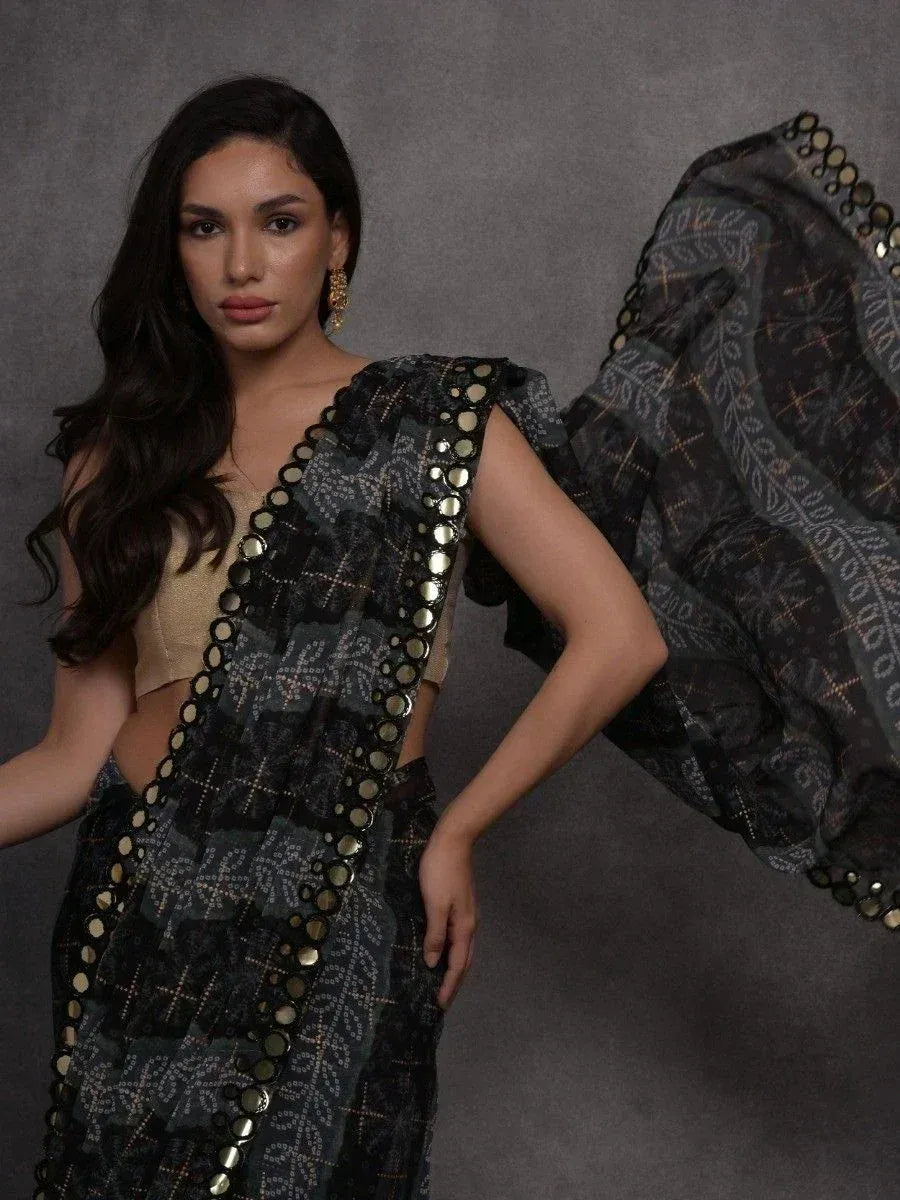 Black printed saree with gold mirror work, paired with beige blouse, ethnic wear for women