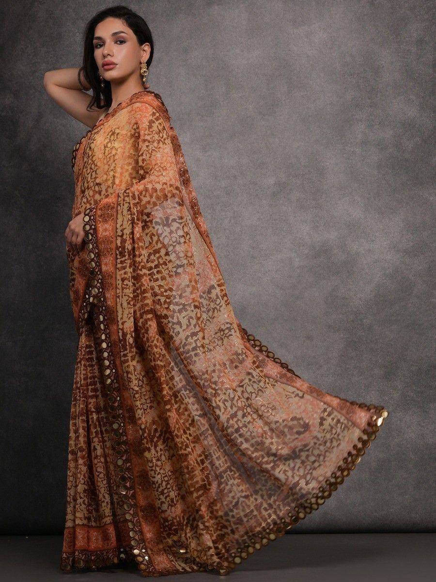 Elegant Indian saree with intricate print and gold embellishments, perfect for ethnic occasions