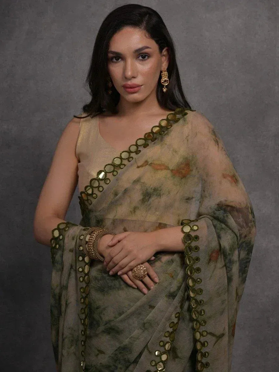 Woman in elegant ethnic saree with gold mirror work, perfect for Indian occasions and festive wear.