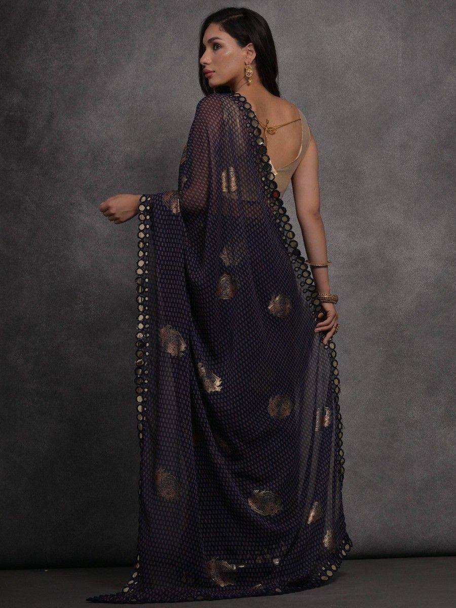 Elegant navy blue saree with gold floral motifs and scalloped border, paired with a beige blouse.