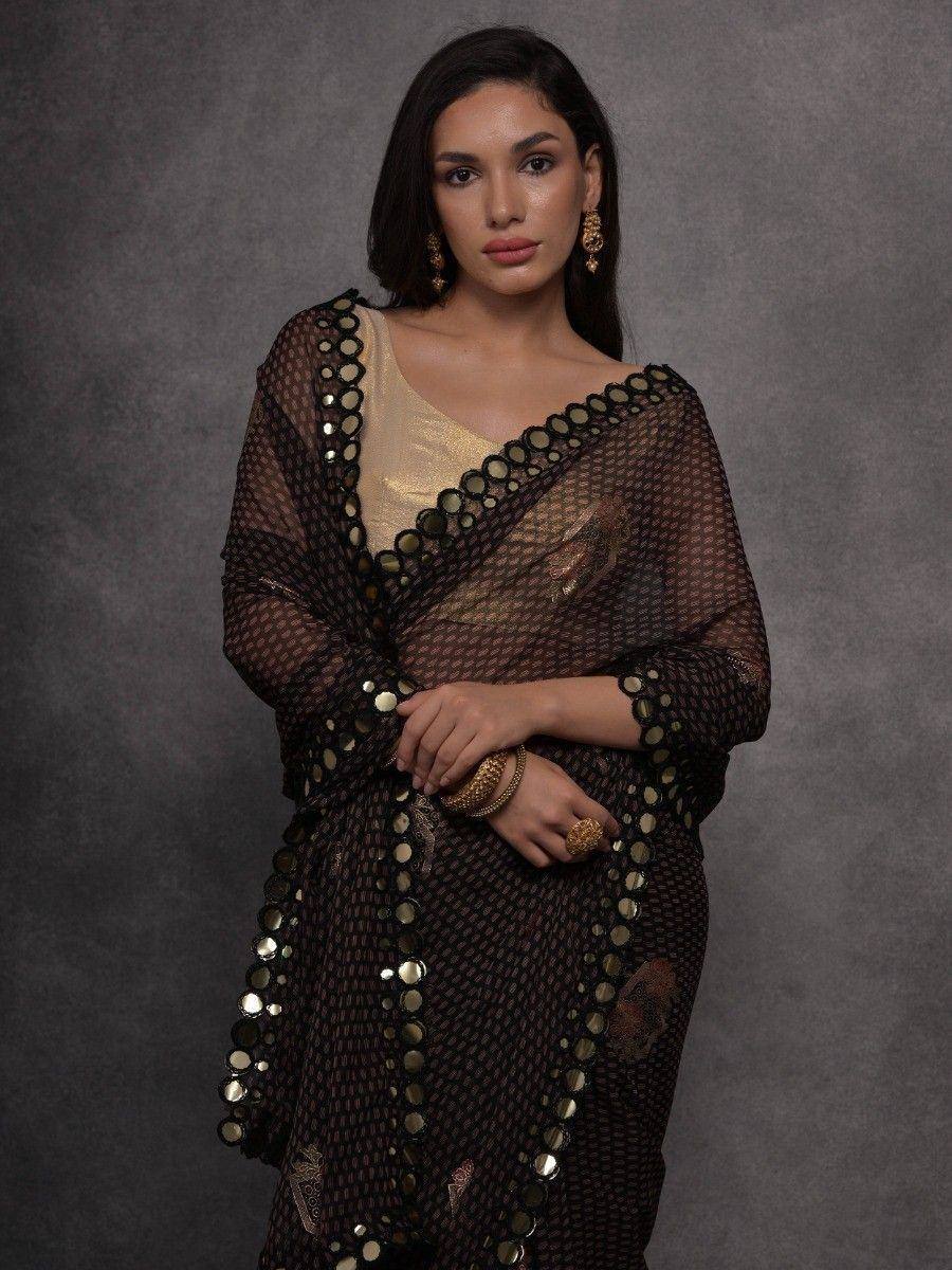 Black sheer saree with gold mirror work, paired with golden blouse, ethnic Indian wear