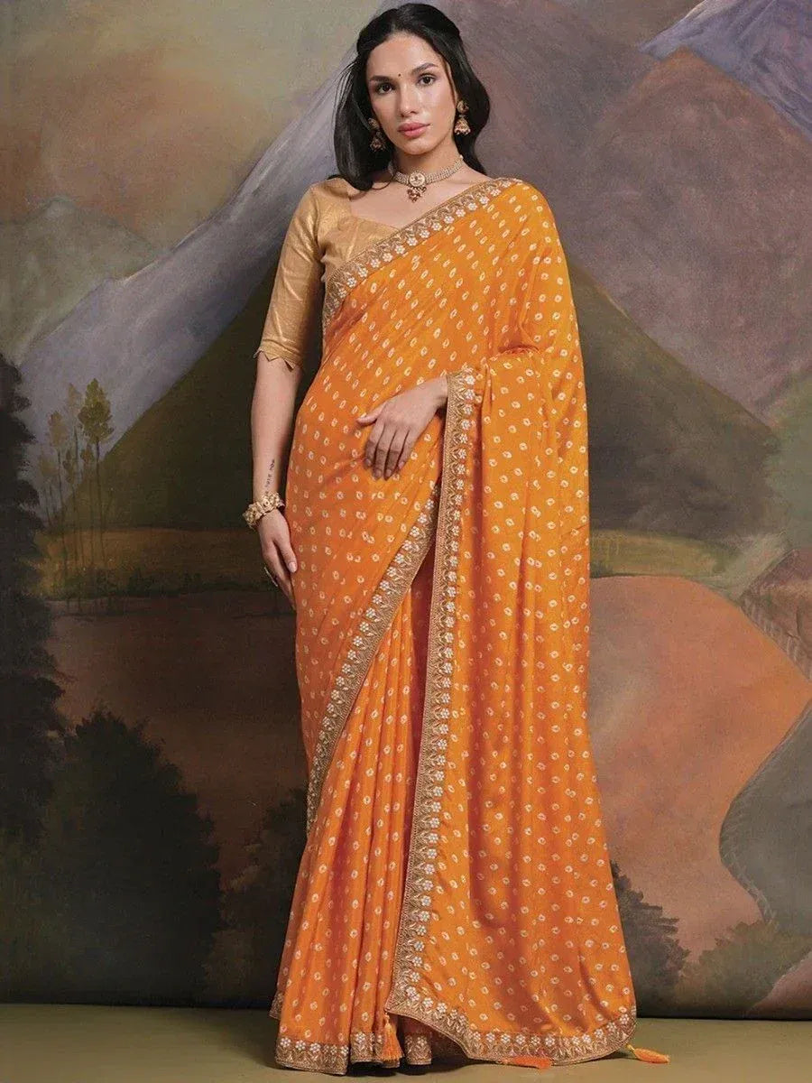 Orange printed saree with gold border, styled with blouse and jewelry for ethnic wear