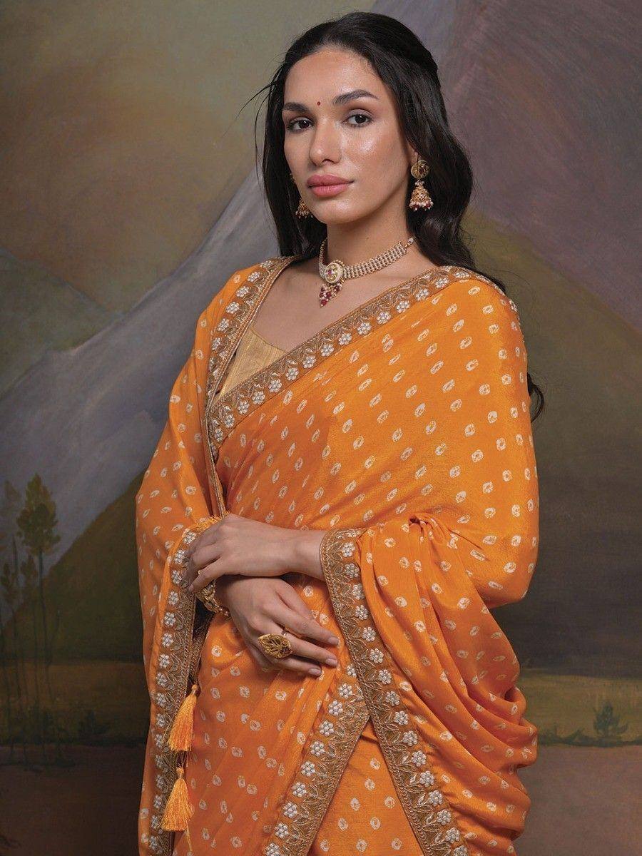 Orange printed saree with gold embroidery, perfect for Indian ethnic wear occasions