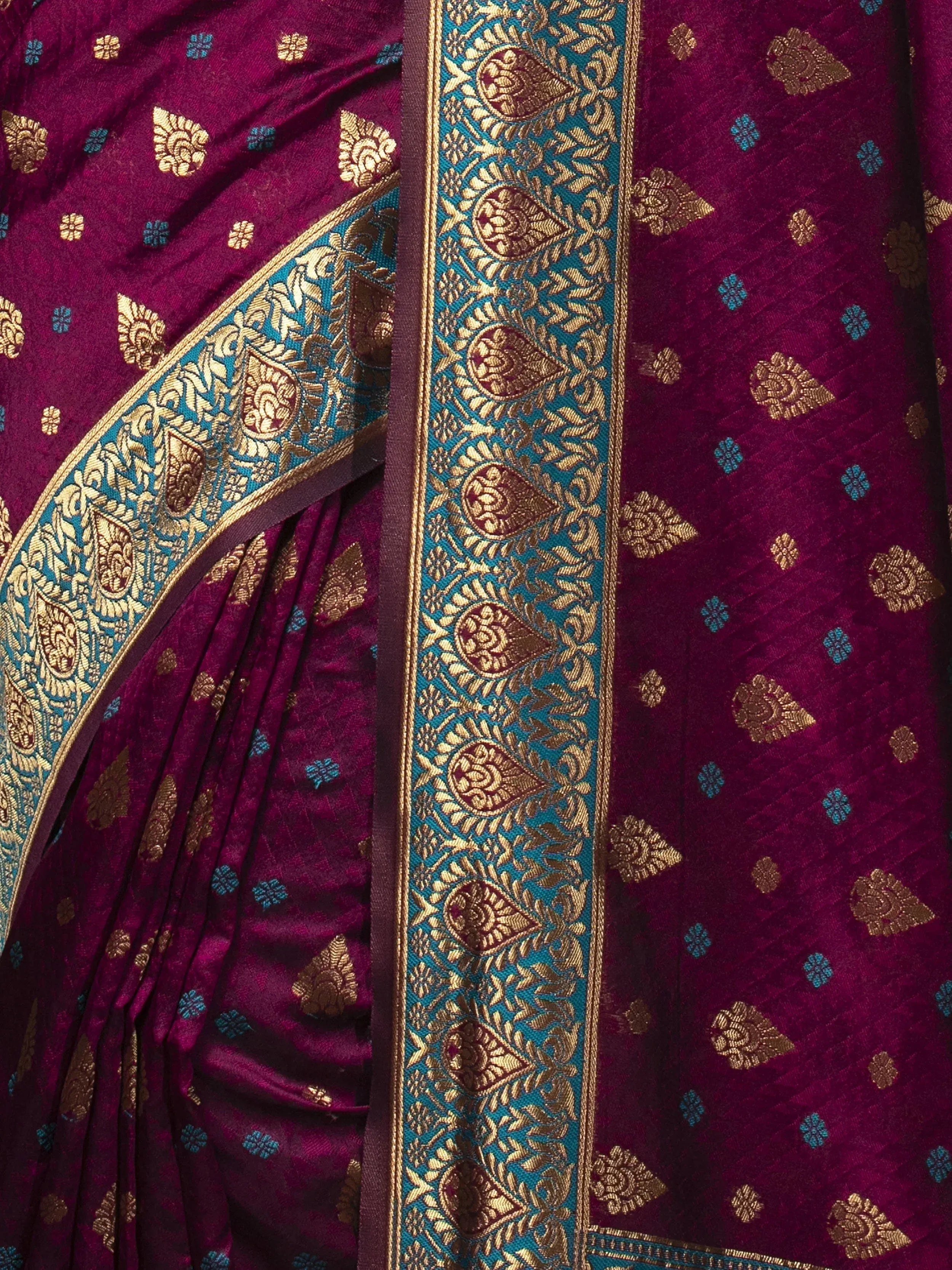 Rich maroon saree with gold and turquoise zari border, perfect for Indian ethnic wear occasions.