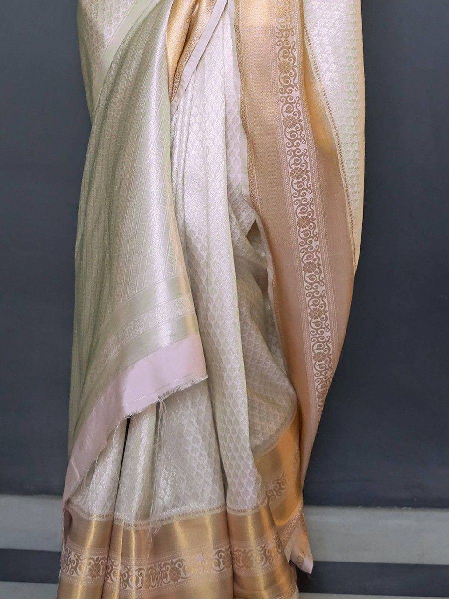 Elegant cream and gold saree with intricate zari border, perfect for Indian ethnic wear occasions.