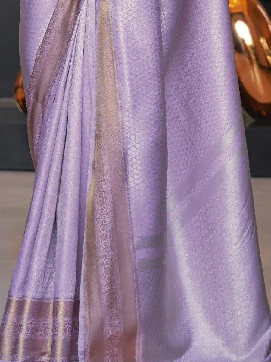 Lavender silk saree with gold border and intricate woven patterns, ideal for ethnic occasions
