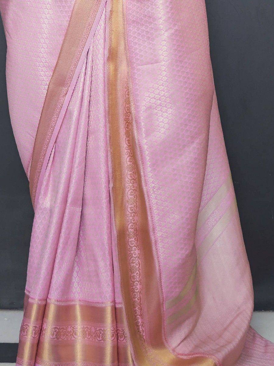 Pink designer saree with gold border and intricate woven pattern, ideal for ethnic occasions