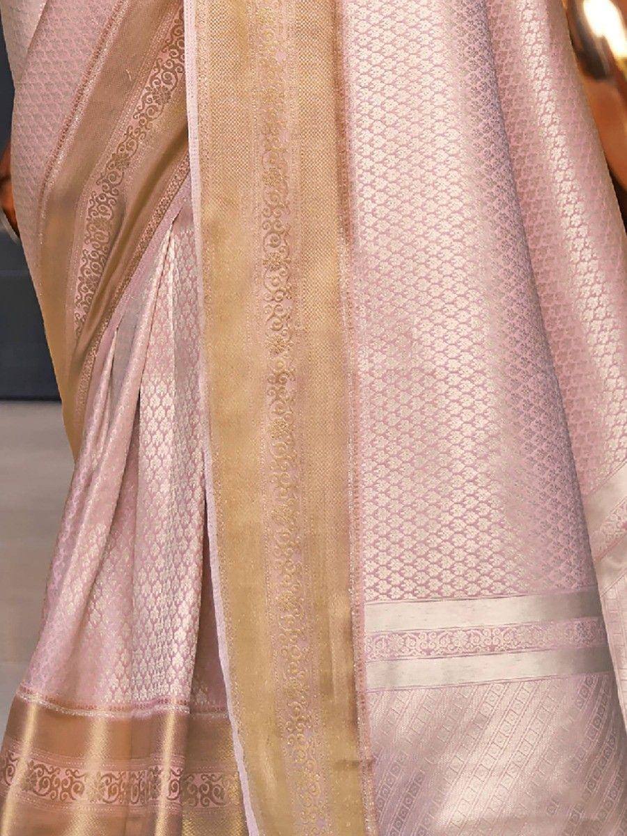 Pink and gold designer saree with intricate woven patterns and border details