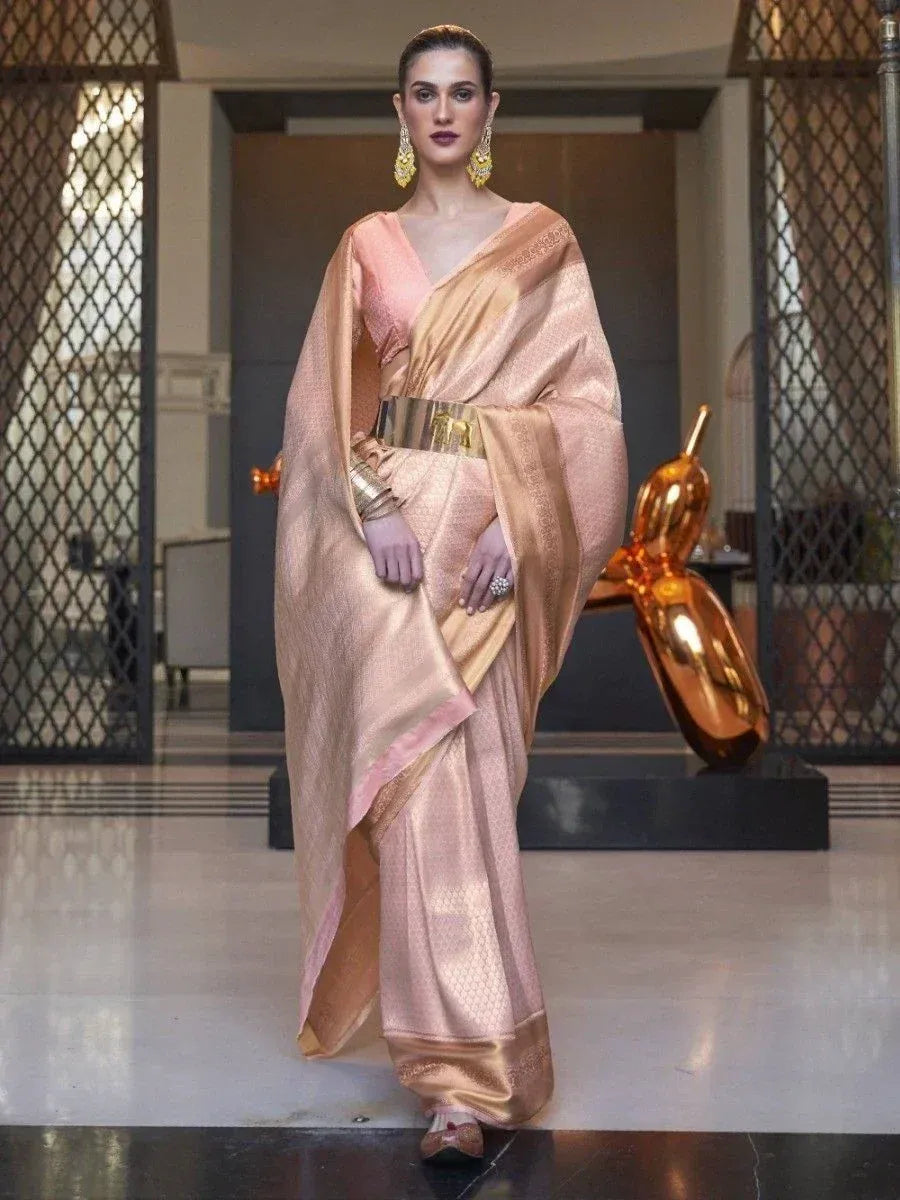 Elegant peach saree with gold border, designer blouse, and statement belt for Indian ethnic wear
