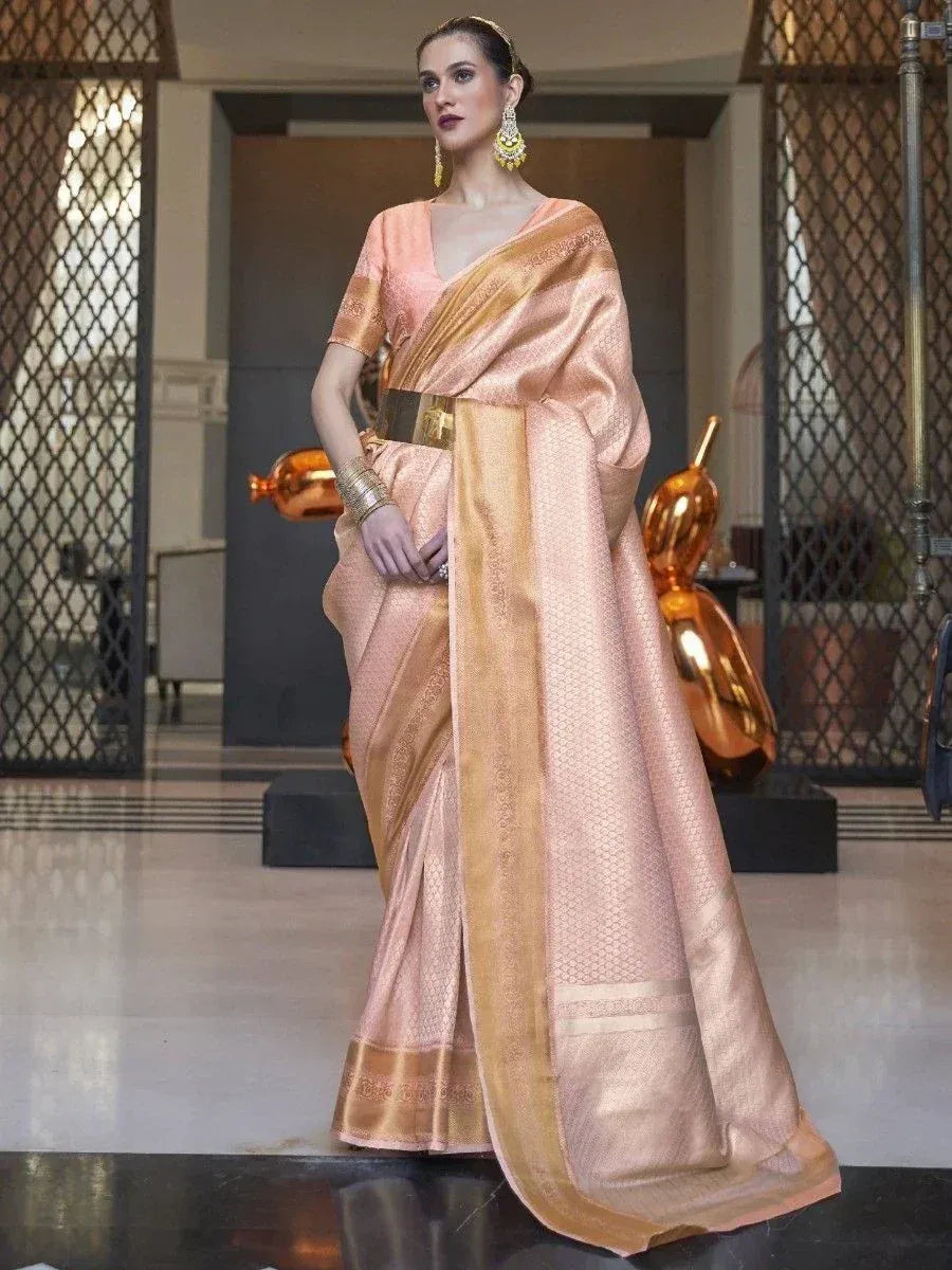Elegant peach silk saree with gold border, perfect for Indian ethnic wear occasions