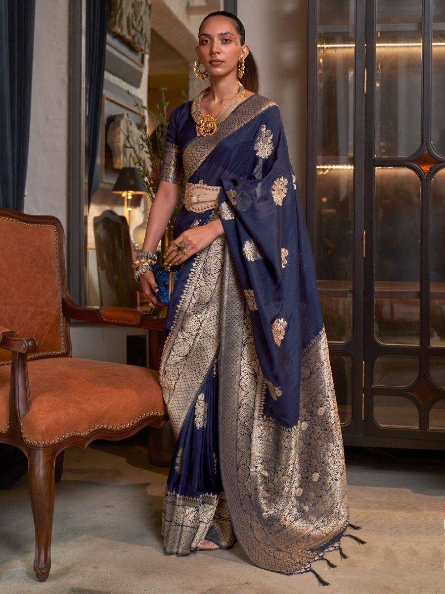 Elegant navy blue saree with gold floral embroidery and intricate border, paired with matching blouse and statement jewelry.