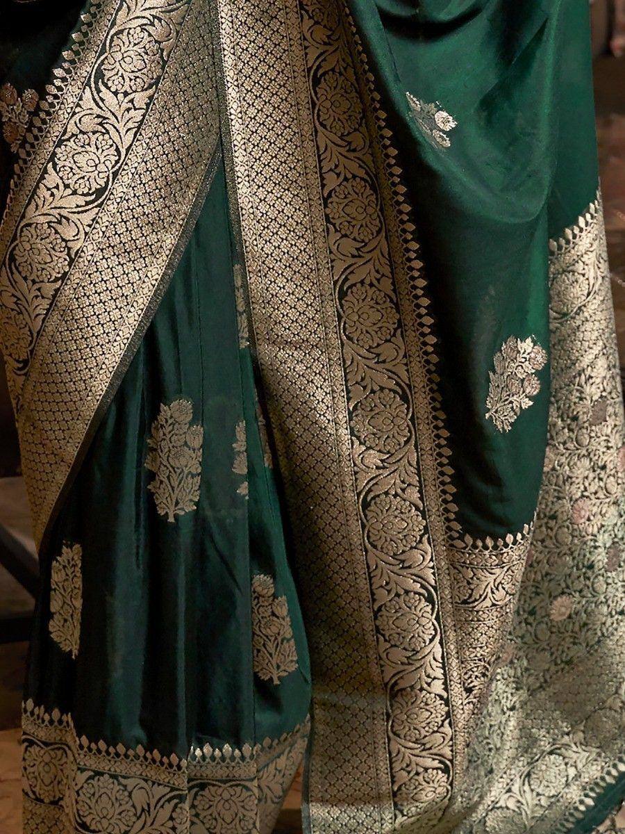 Emerald green silk saree with intricate gold zari floral border and motifs, perfect for ethnic occasions.