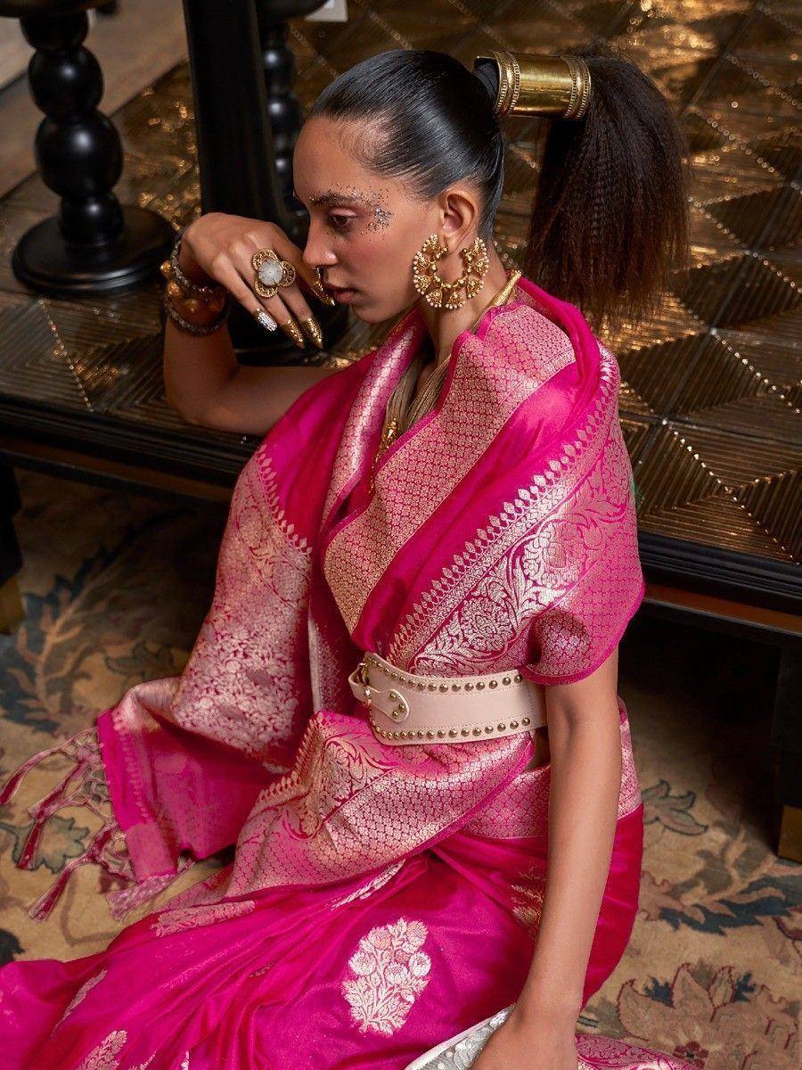 Pink designer saree with gold embroidery, styled with statement jewelry and belt for ethnic wear