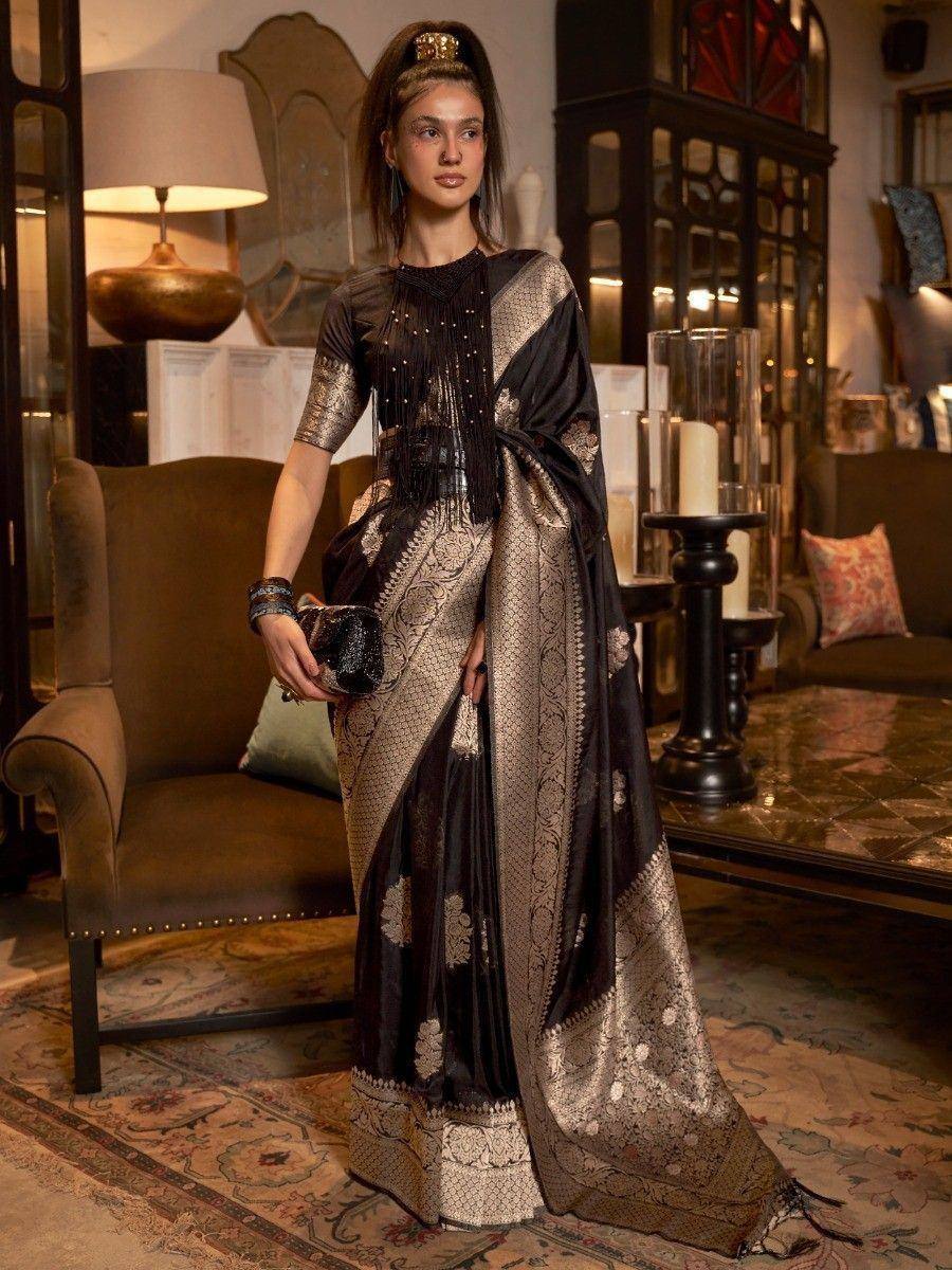 Black and gold designer saree with intricate embroidery and fringe detailing, styled for ethnic occasions.