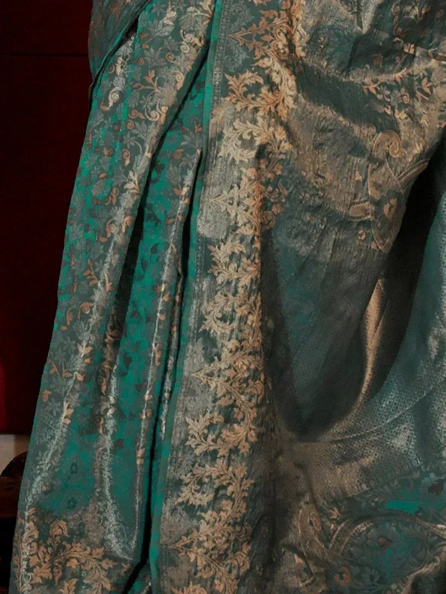 Emerald green ethnic saree with gold floral embroidery, perfect for Indian weddings and festive occasions.