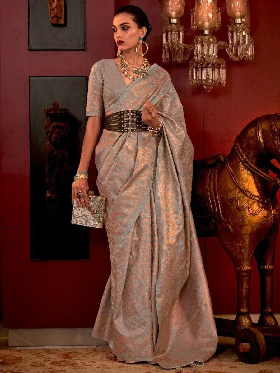 Elegant woman in designer saree with belt, ethnic jewelry, and clutch, perfect for Indian occasions