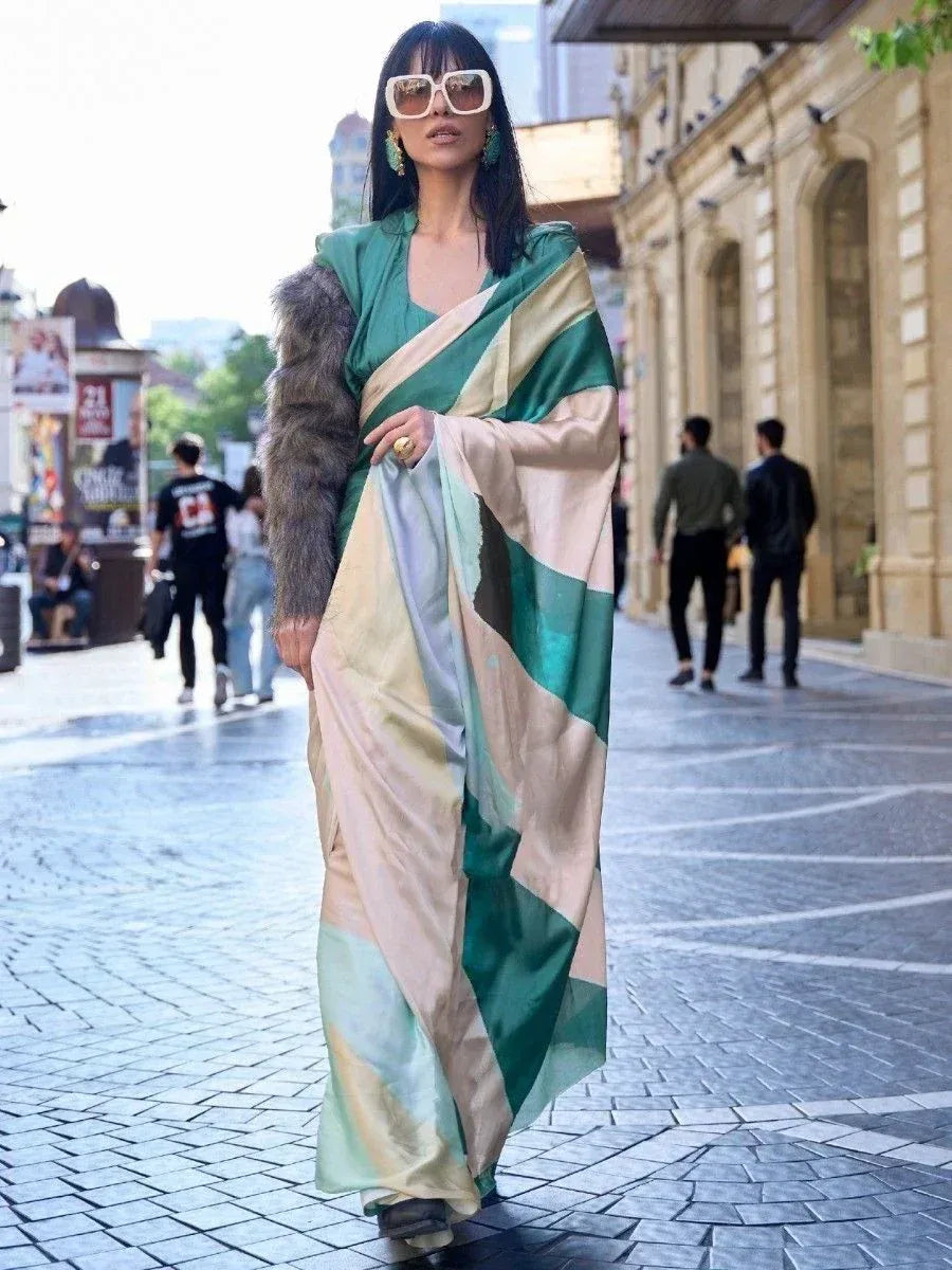 Stylish woman in green and beige designer saree with fur jacket, walking on city street