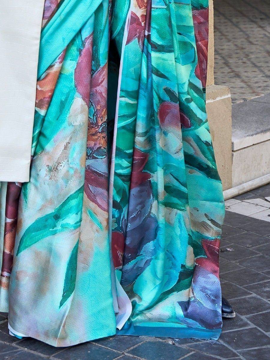 Vibrant floral print saree in teal and burgundy, perfect for ethnic wear occasions.