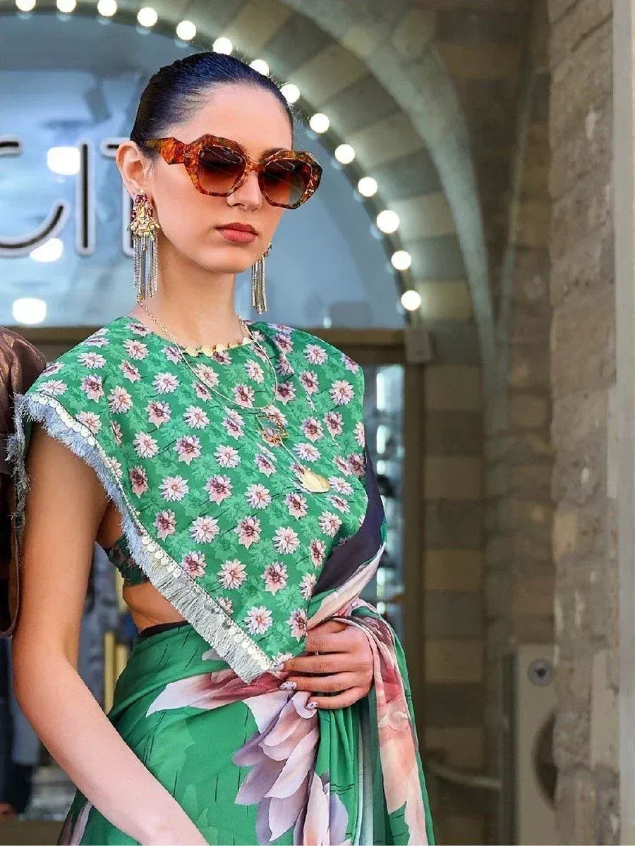 Green floral printed saree with fringe border, styled with statement earrings and sunglasses