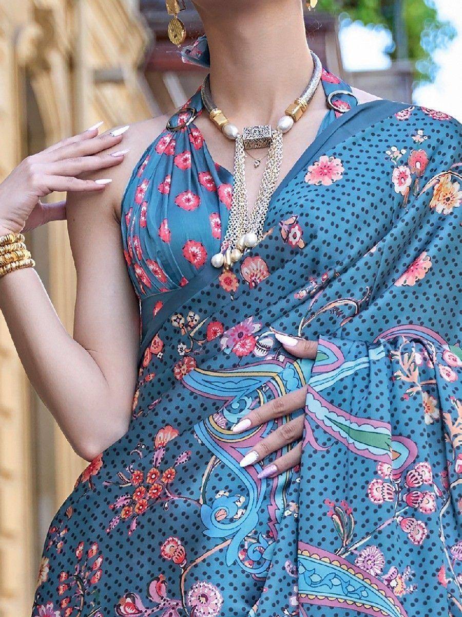 Blue floral printed saree with polka dots, paired with gold jewelry and statement necklace