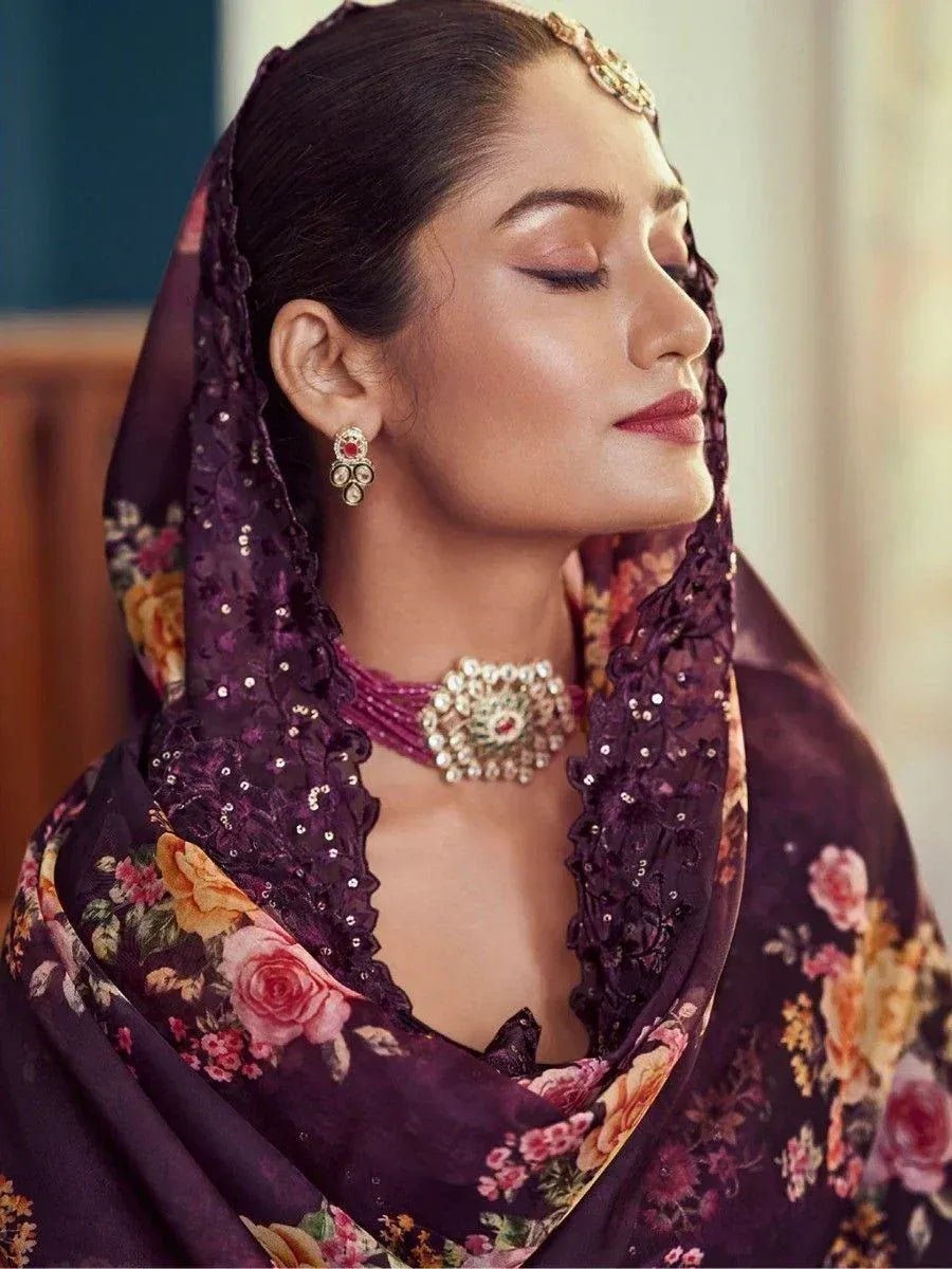 Woman in purple floral dupatta with traditional jewelry, ethnic wear fashion.