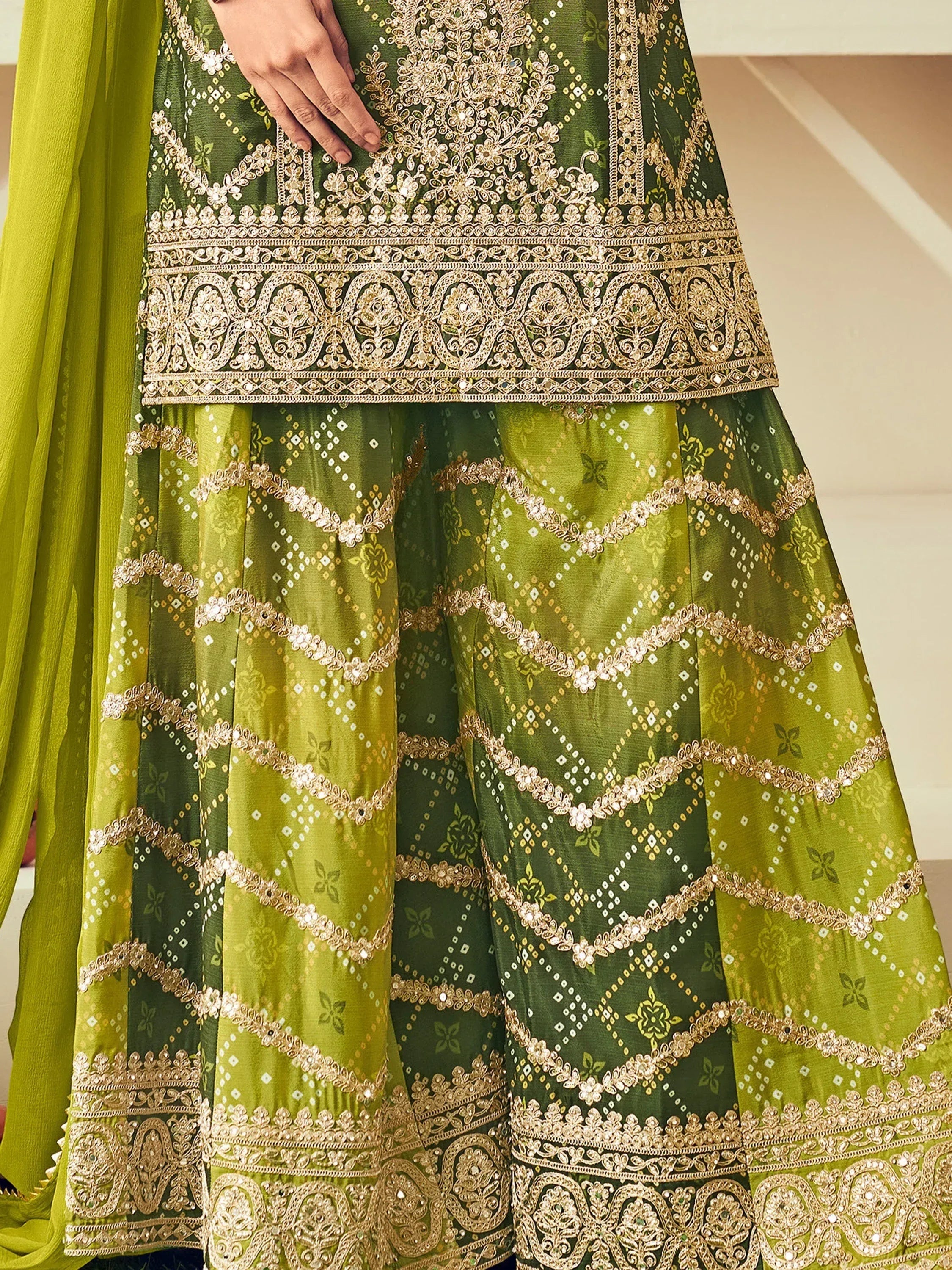 Green embroidered lehenga choli with gold zari work and mirror detailing, perfect for Indian ethnic wear.