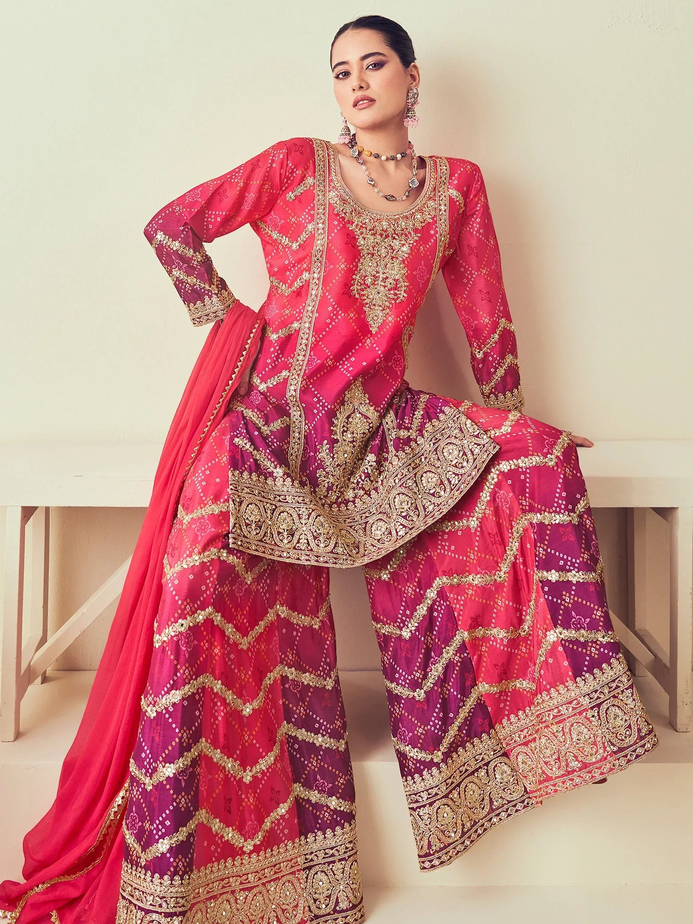 Pink and purple embroidered salwar kameez with gold detailing, perfect for Indian ethnic wear occasions