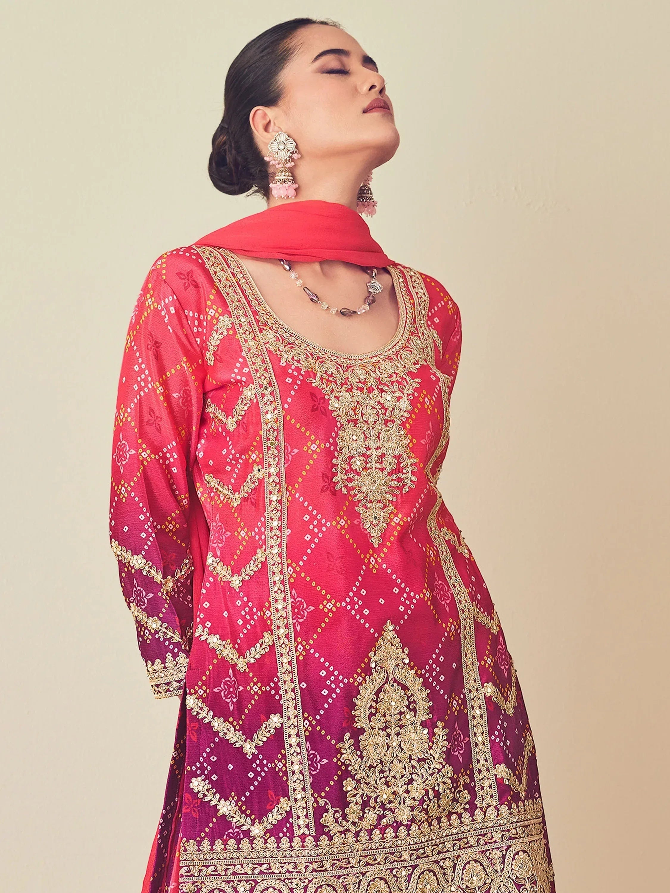 Pink embroidered ethnic kurti with gold detailing, perfect for festive occasions and traditional wear.