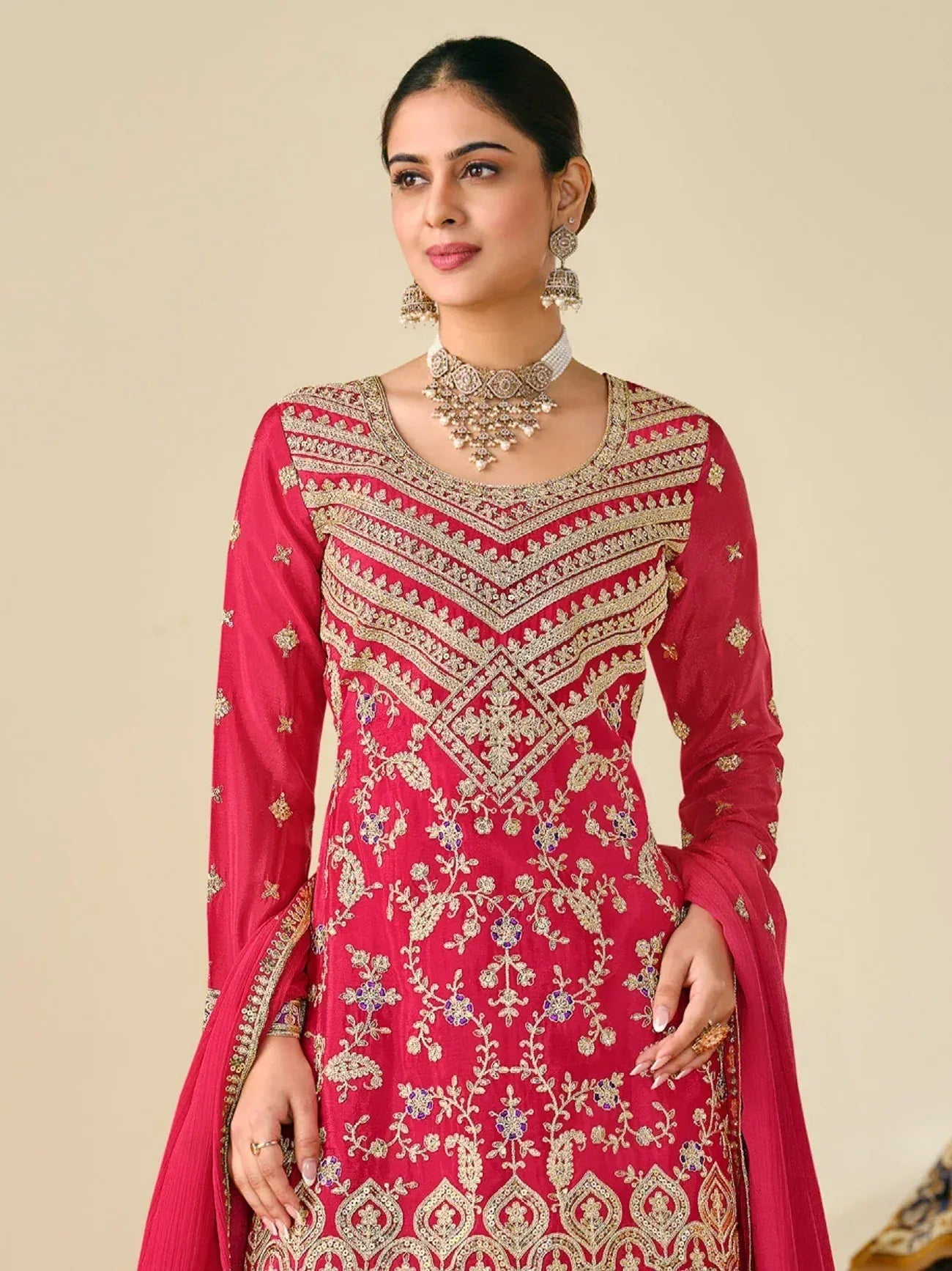 Elegant red ethnic gown with gold embroidery, perfect for Indian celebrations and weddings
