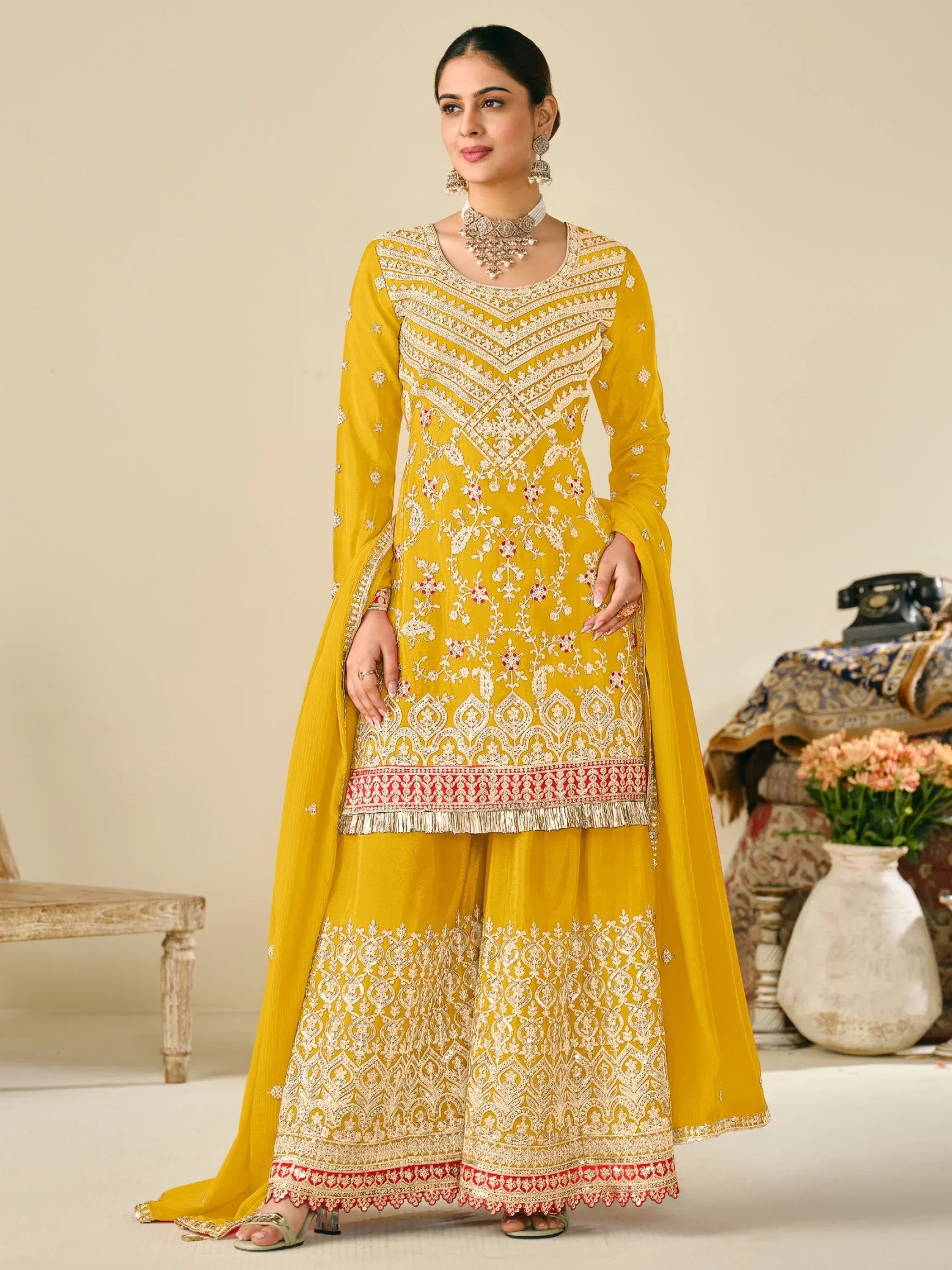 Yellow embroidered salwar kameez with white and red detailing, perfect for Indian ethnic occasions