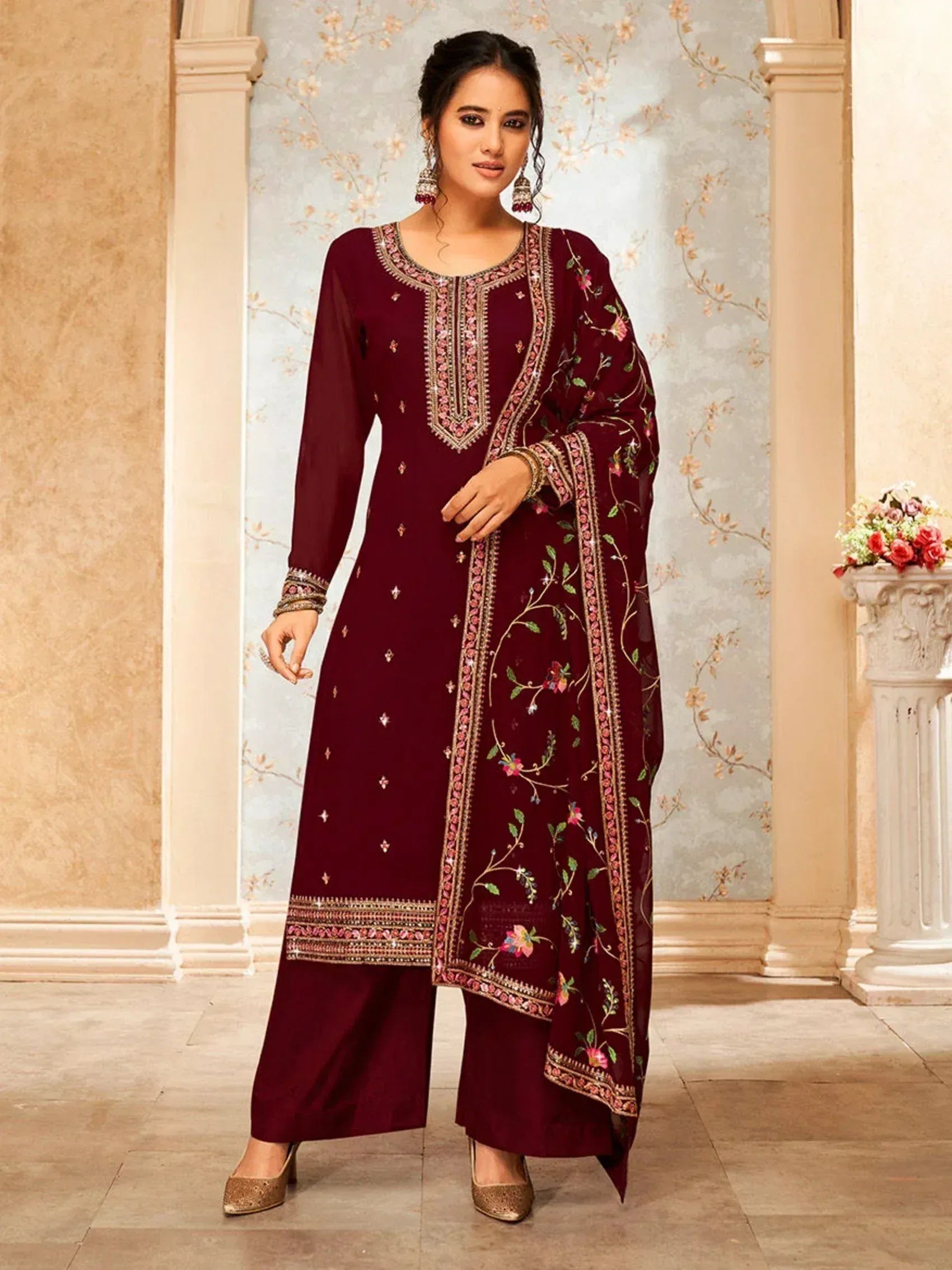 Woman wearing maroon embroidered salwar kameez with floral dupatta, ethnic Indian attire