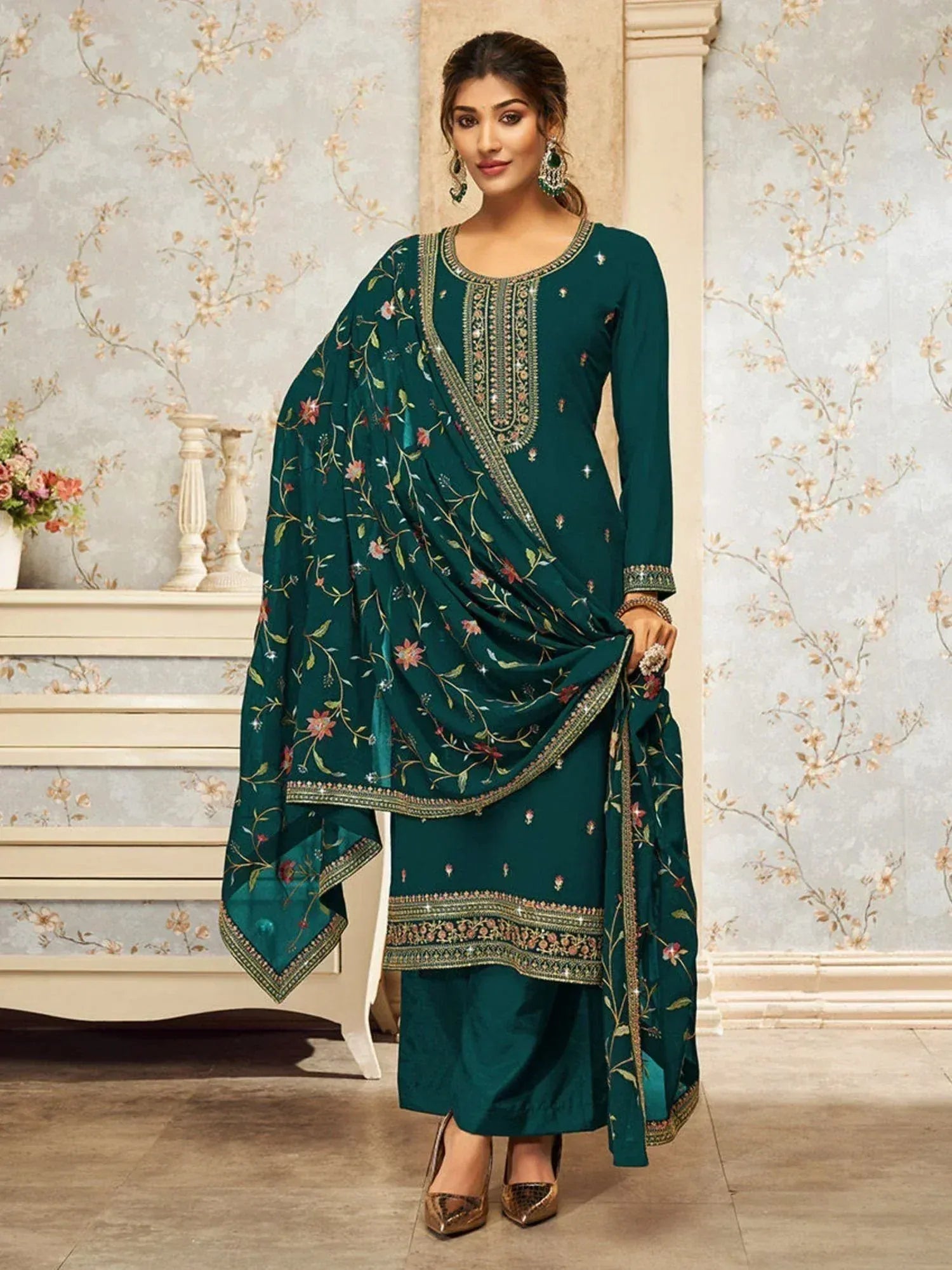 Woman wearing green embroidered salwar kameez with floral dupatta, traditional Indian attire