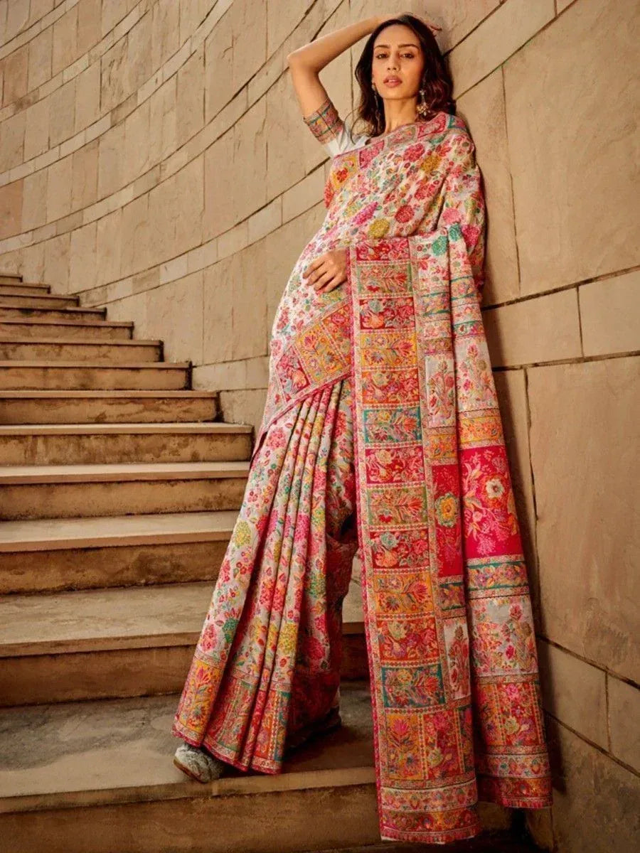Woman in colorful floral printed saree with patchwork border, styled for ethnic occasions