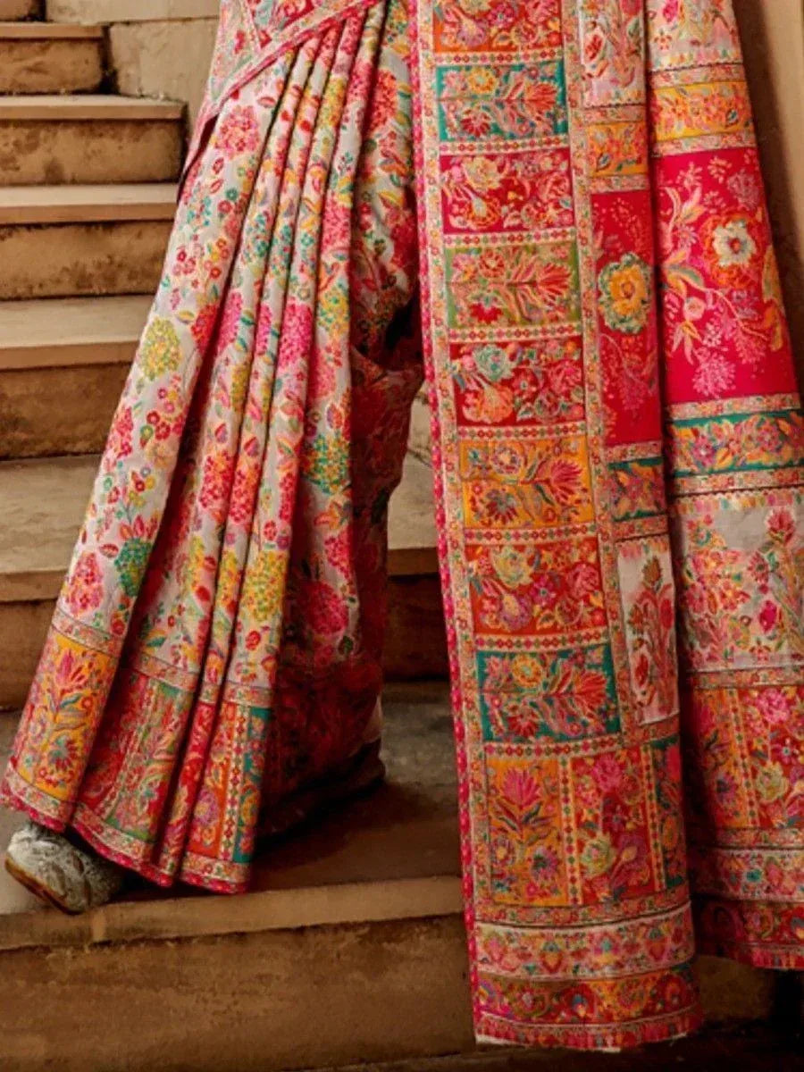 Vibrant floral printed Indian saree with colorful border, styled on stairs for ethnic wear look