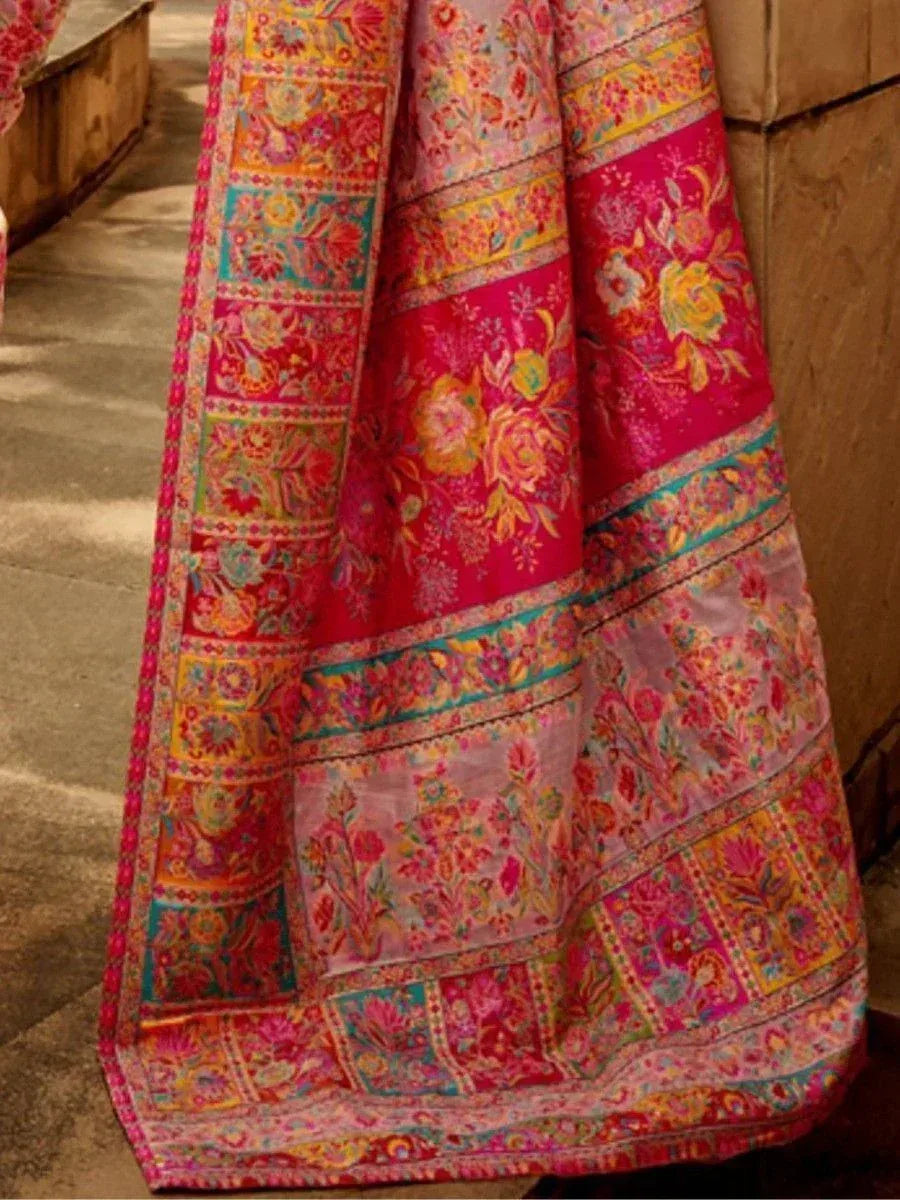 Vibrant pink floral lehenga with intricate embroidery and colorful borders, perfect for Indian ethnic wear