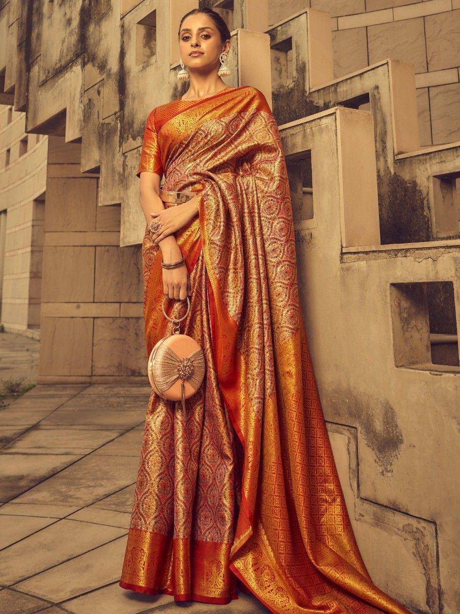 Elegant orange and gold designer saree with intricate patterns, perfect for ethnic occasions