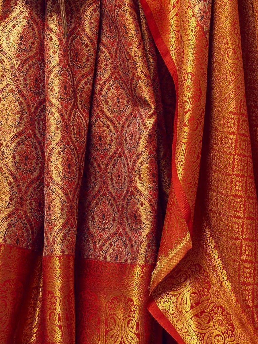 Rich red and gold Indian ethnic saree with intricate brocade patterns, perfect for festive occasions.