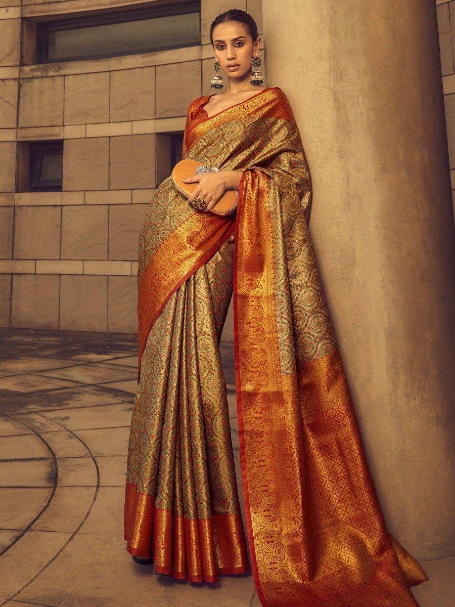 Elegant gold and orange designer saree with intricate patterns, perfect for ethnic occasions