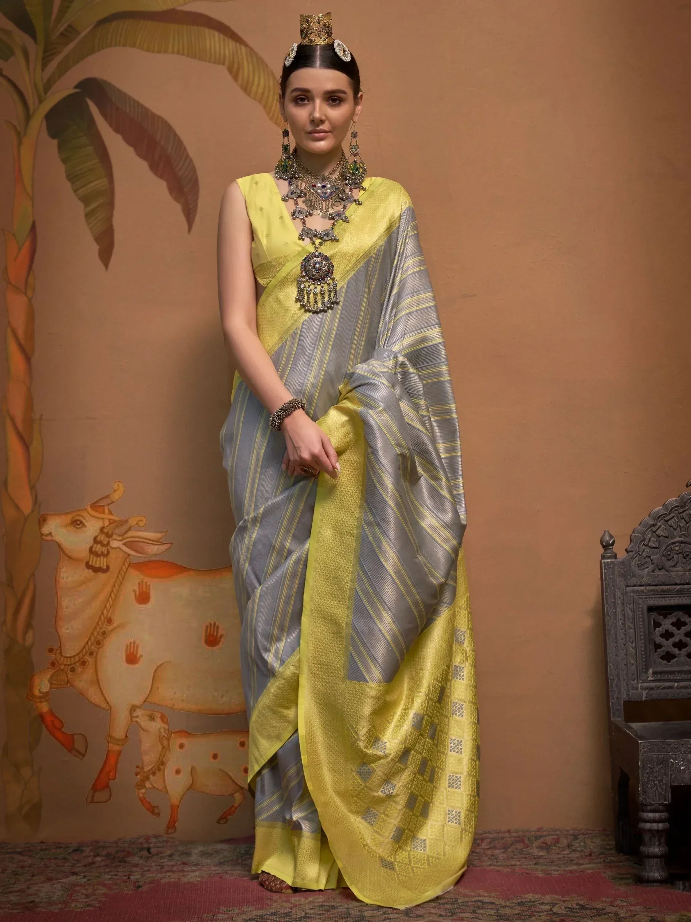 Yellow and grey striped saree with traditional jewelry, ethnic Indian wear